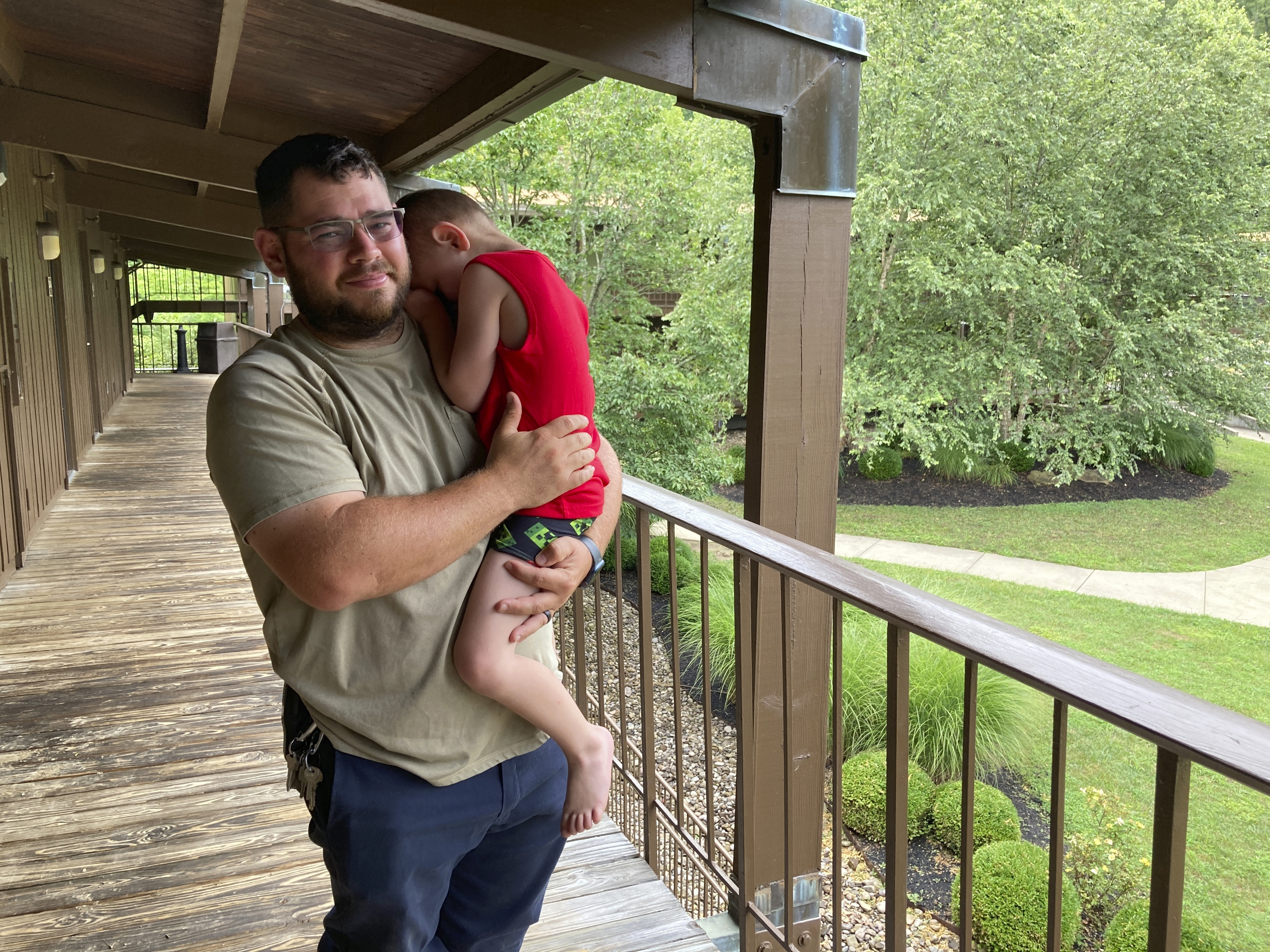 Phillip Michael Caudill holds his 4-year-old son Connor outside their temporary room at Jenny Wiley State Park in Prestonsburg, Ky., on Saturday. The state park is serving a as a shelter for flooding victims. Caudill and his family had to flee their home in Wayland, Ky., early Thursday as floodwaters rushed in when heavy rains pounded eastern Kentucky.