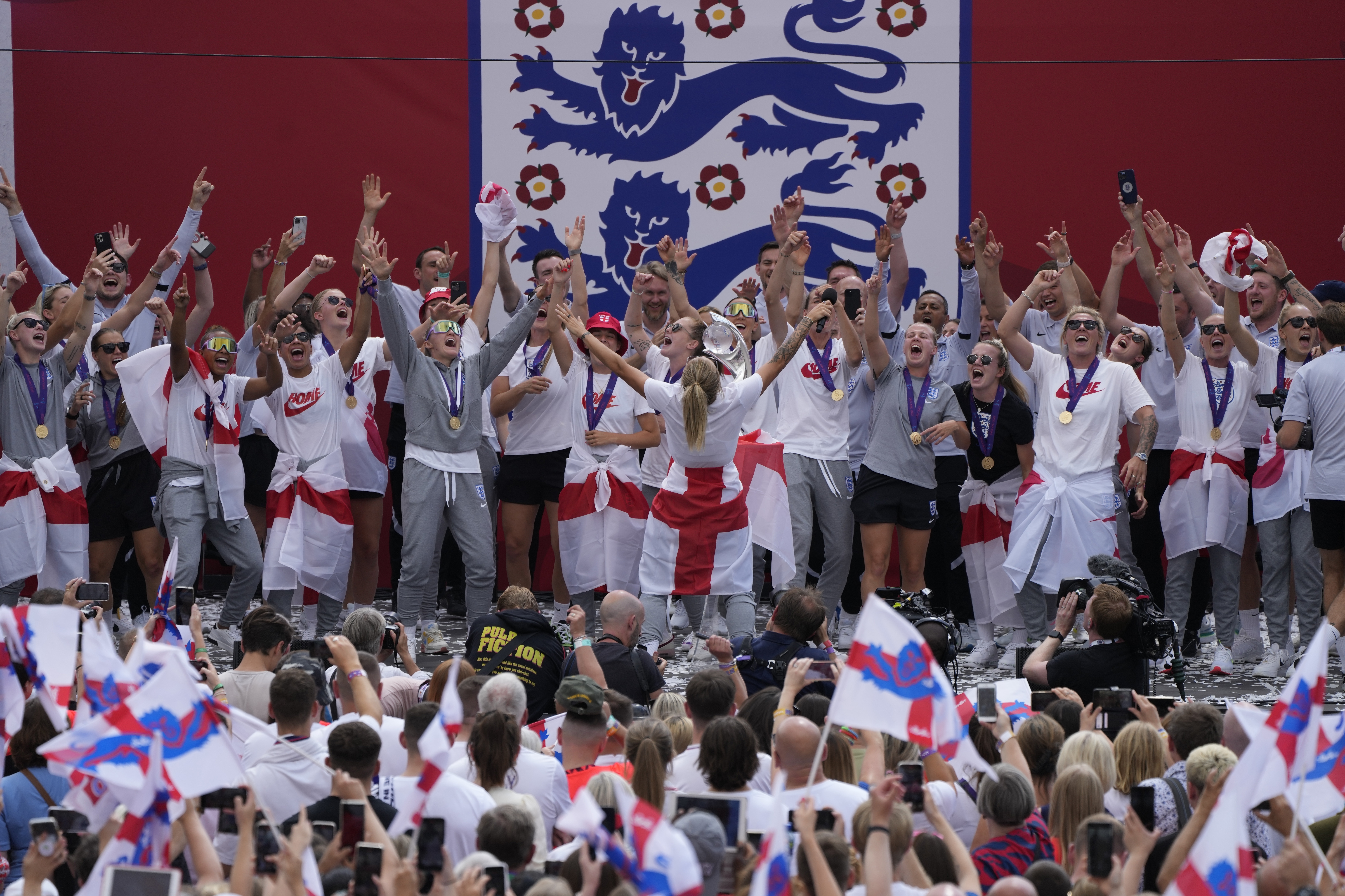 England players celebrate on stage at an event at Trafalgar Square in London, Monday, Aug. 1, 2022. England beat Germany 2-1 and won the final of the Women's Euro 2022 on Sunday. 