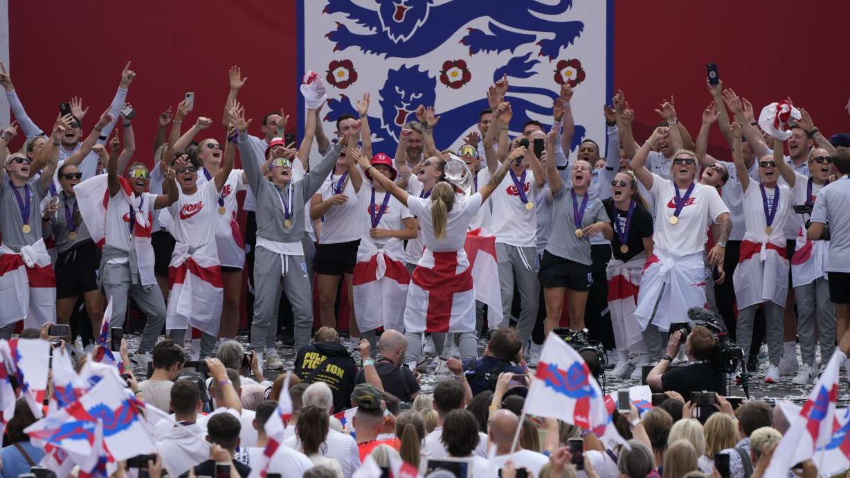 England players celebrate on stage at an event at Trafalgar Square in London, Monday, Aug. 1, 2022. England beat Germany 2-1 and won the final of the Women's Euro 2022 on Sunday.