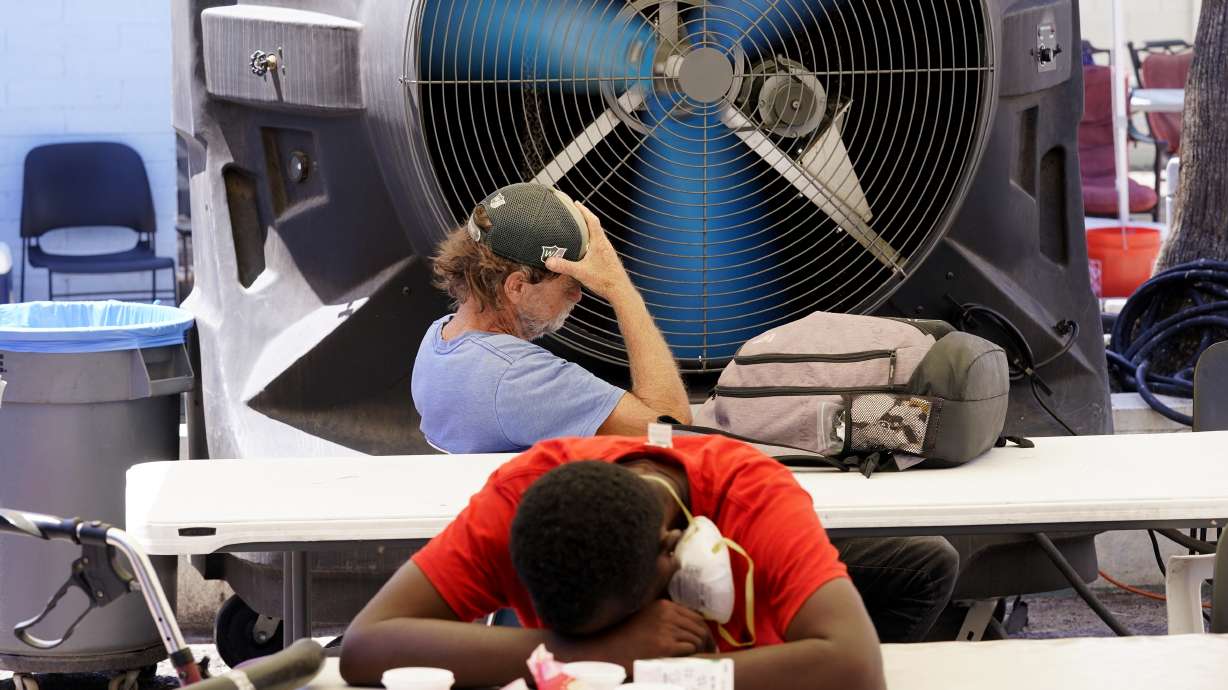 People try to keep cool at the Justa Center, a resource center catering to the older homeless population, as temperatures hit 110-degrees, July 19, in Phoenix. The Biden Administration Tuesday, July 26, unveiled a new website, heat.gov, that federal officials hope can help people and local governments beat the heat and keep it from getting deadly.
