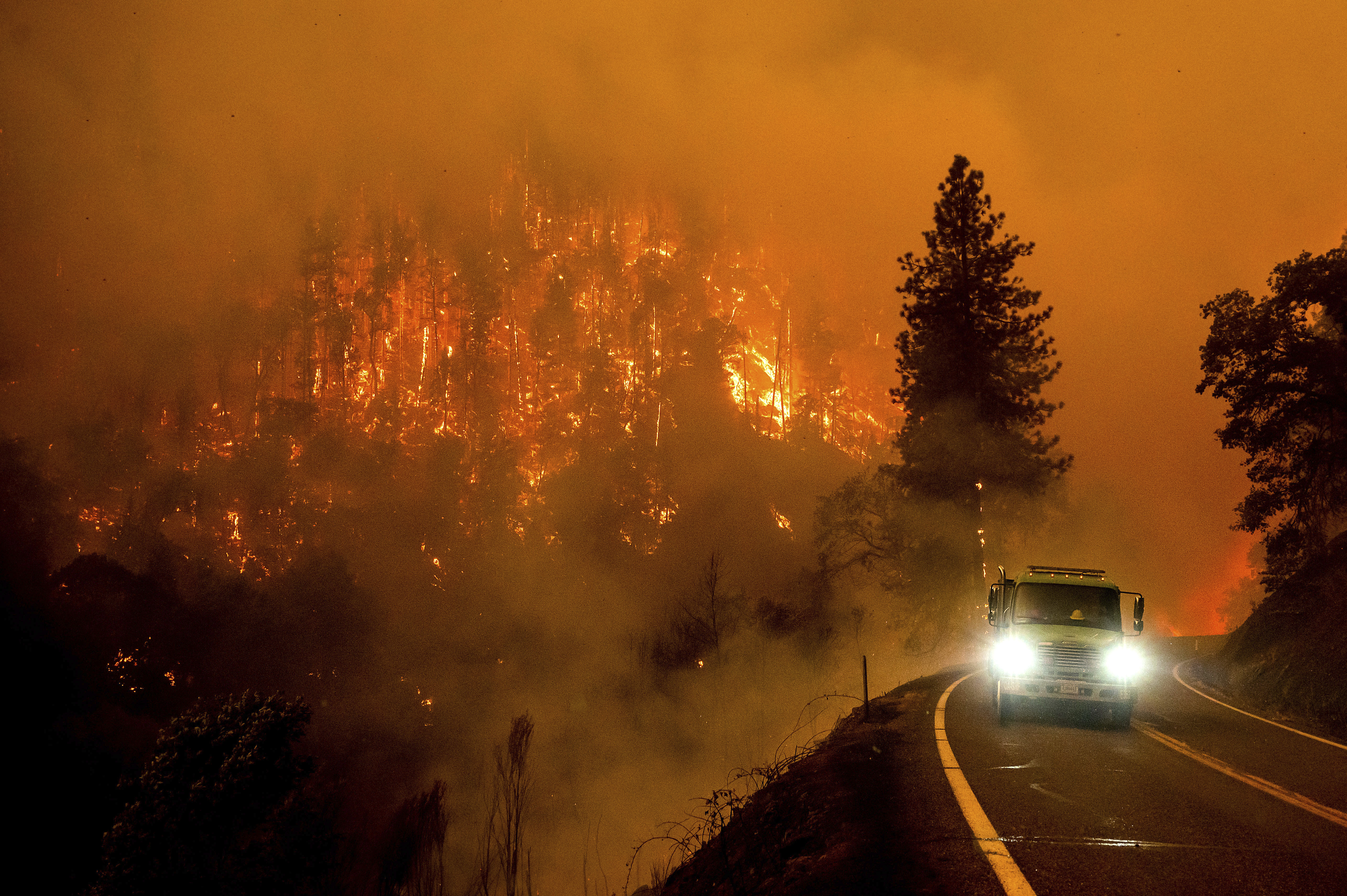 A firetruck drives along California Highway 96 as the McKinney Fire burns in Klamath National Forest, Calif., Saturday.