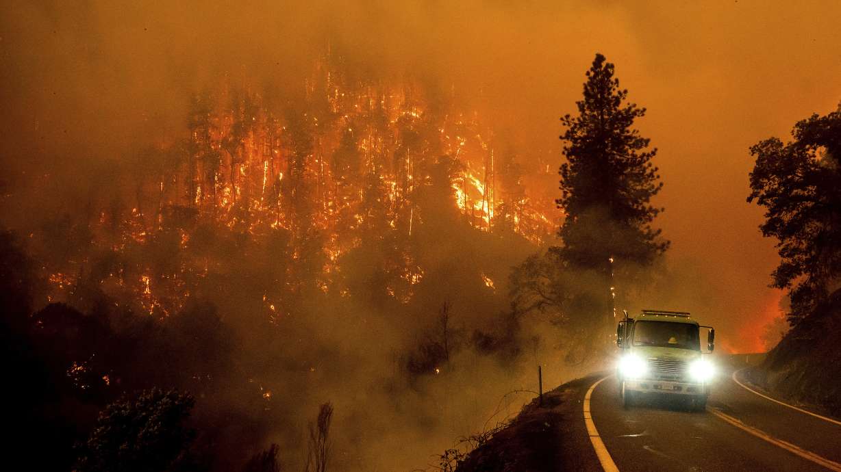 A firetruck drives along California Highway 96 as the McKinney Fire burns in Klamath National Forest, Calif., Saturday.