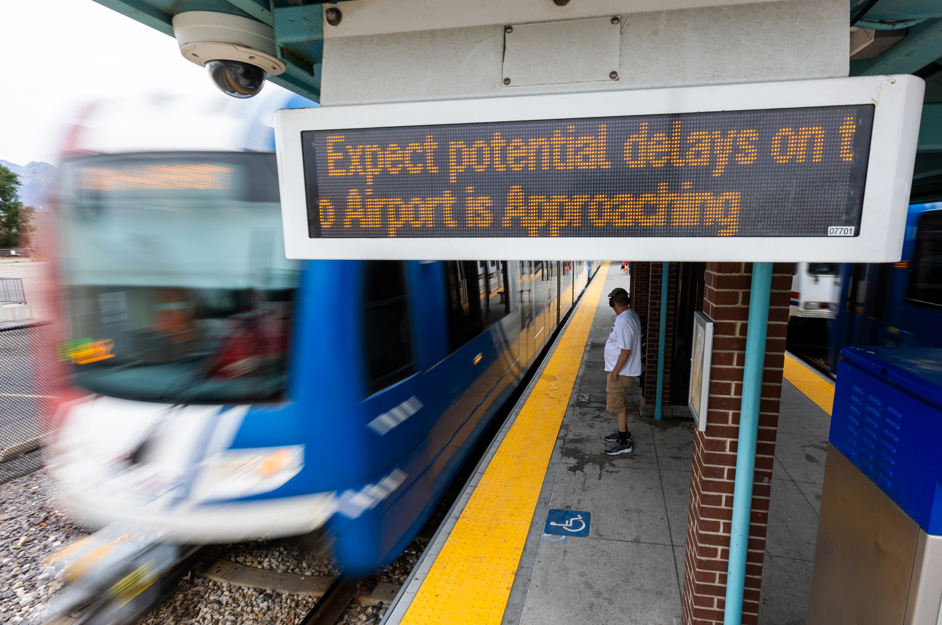A sign at the TRAX Central Pointe Station in South Salt Lake on Monday warns of delays as a train approaches on the Green Line.