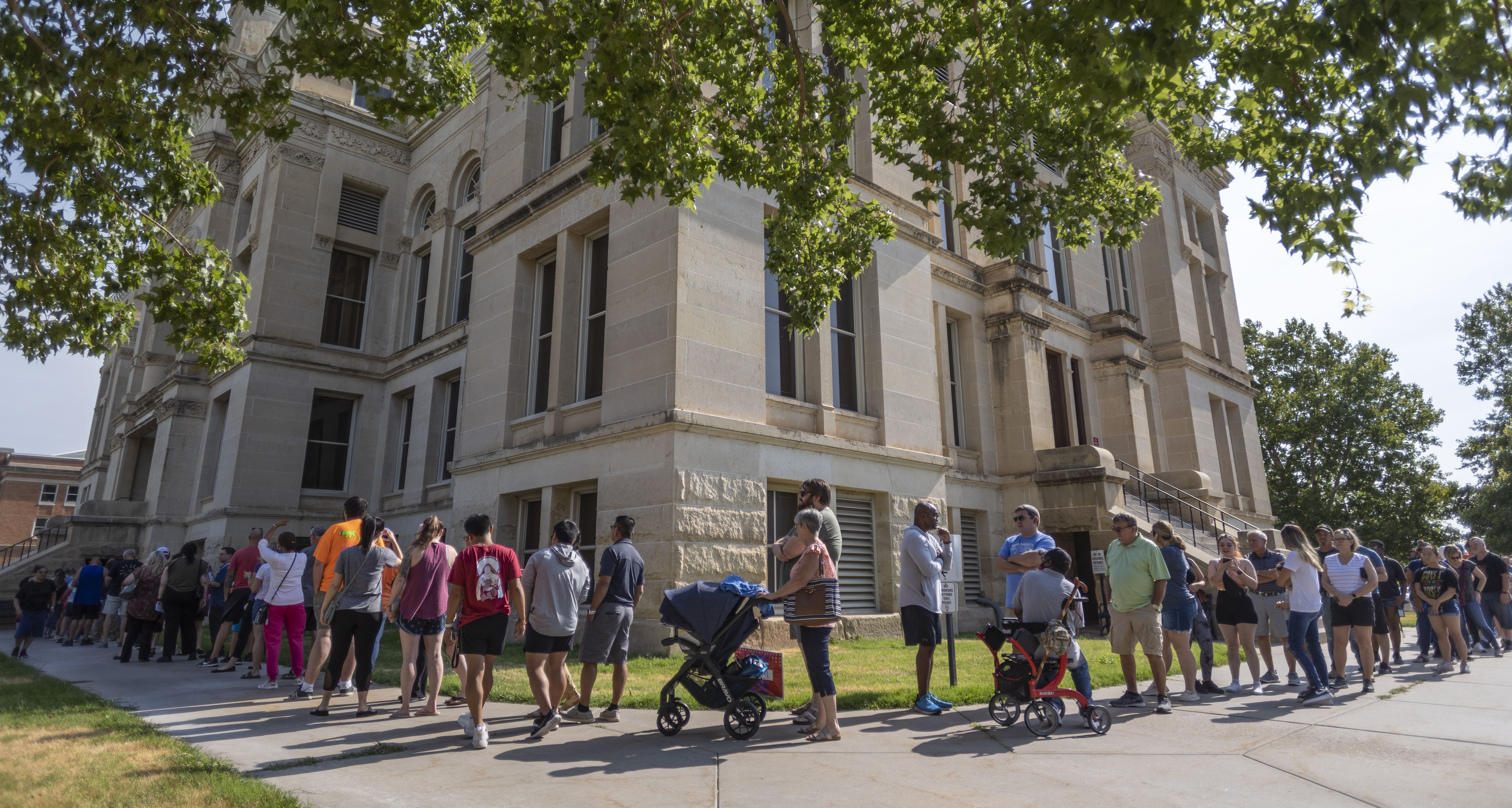 A long line of voters wraps around the Sedgwick County Historic Courthouse in Wichita, Kansas, on the last day of early voting on Monday. Voters will decide on a proposed amendment to the Kansas constitution regarding the regulation of abortion in the state.
