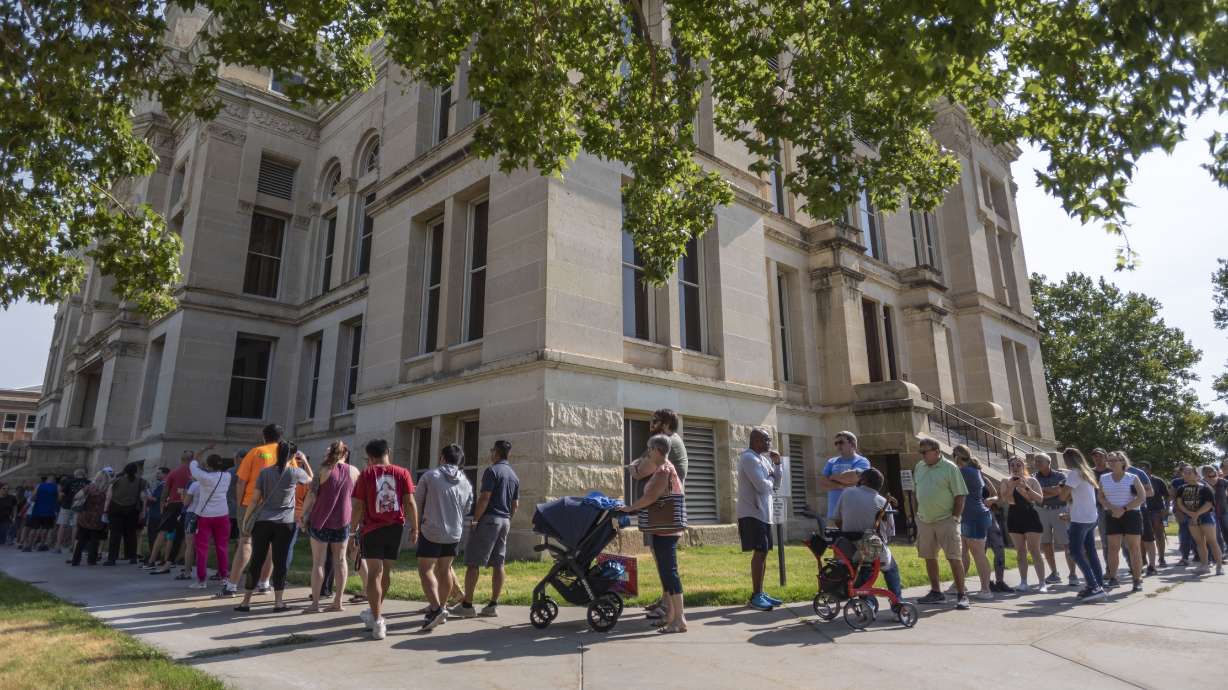 A long line of voters wraps around the Sedgwick County Historic Courthouse in Wichita, Kansas, on the last day of early voting on Monday. Voters will decide on a proposed amendment to the Kansas constitution regarding the regulation of abortion in the state.