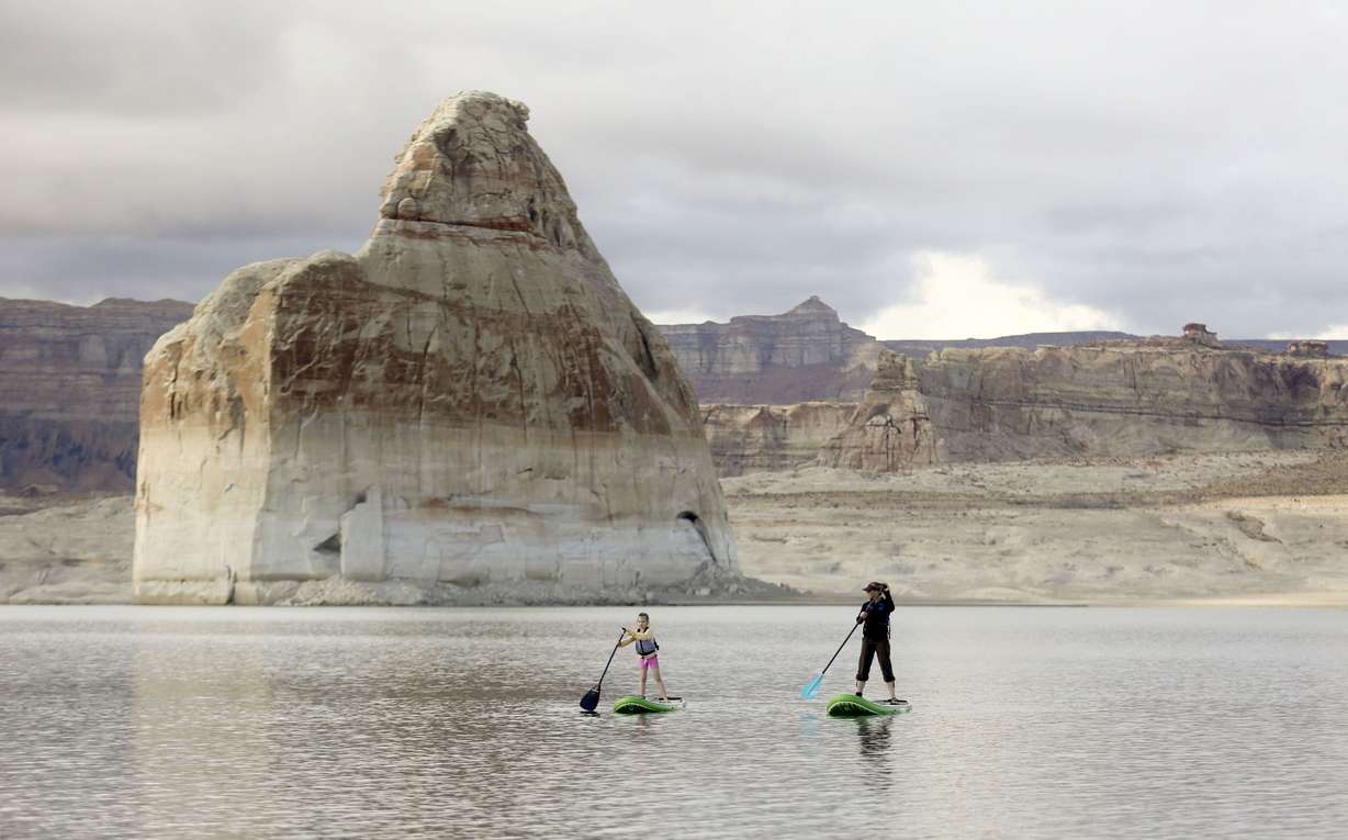 Edyth Hanford and her mother, Melody Hanford, paddleboard in the Glen Canyon National Recreation Area at Lake Powell in Utah on March 27, 2021.