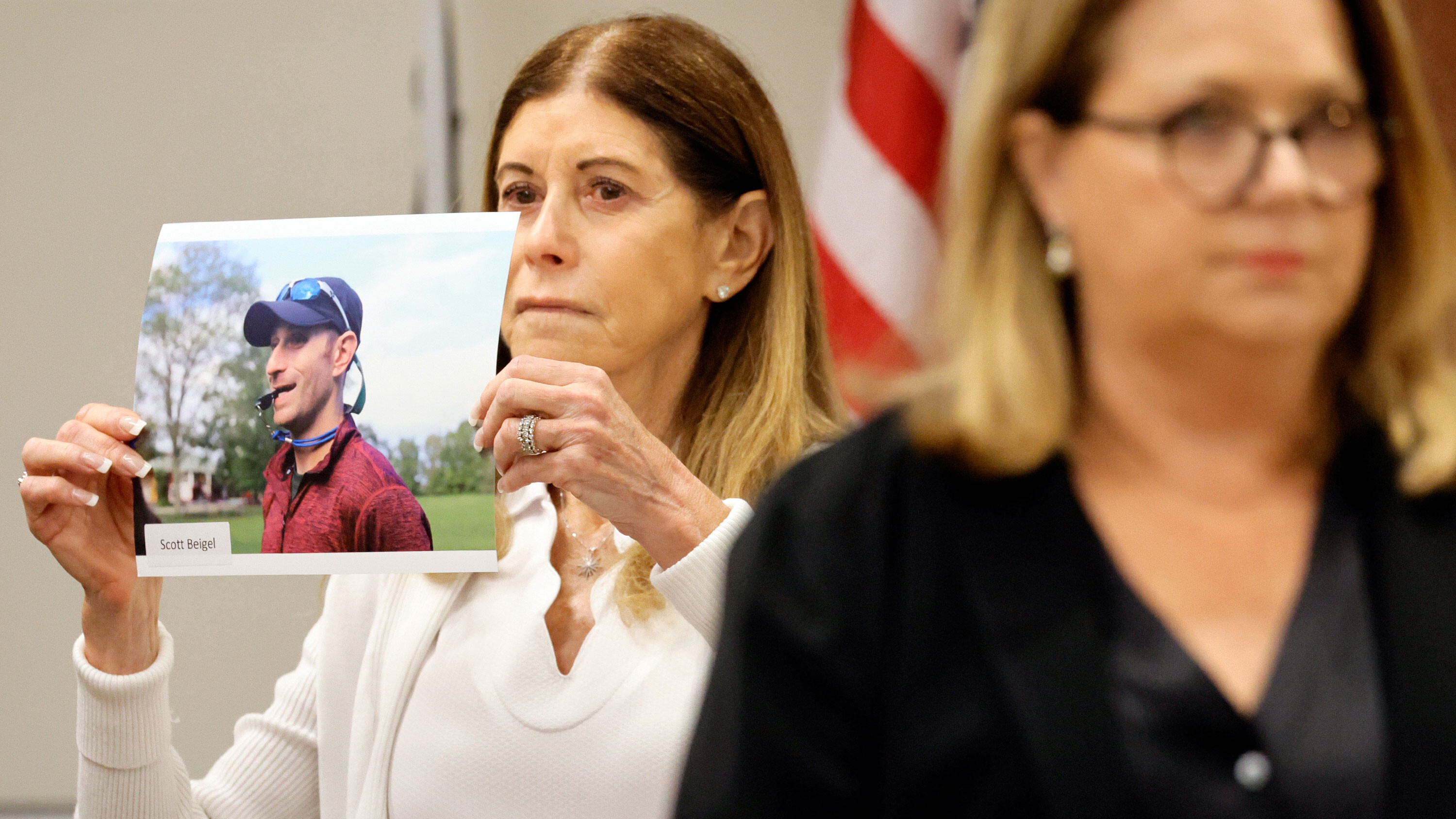 Linda Beigel Schulman holds a photo of her son, Scott Beigel, before giving her victim impact statement on Aug. 1 during the penalty phase of Marjory Stoneman Douglas High School shooter Nikolas Cruz's trial at the Broward County Courthouse in Fort Lauderdale, Florida.