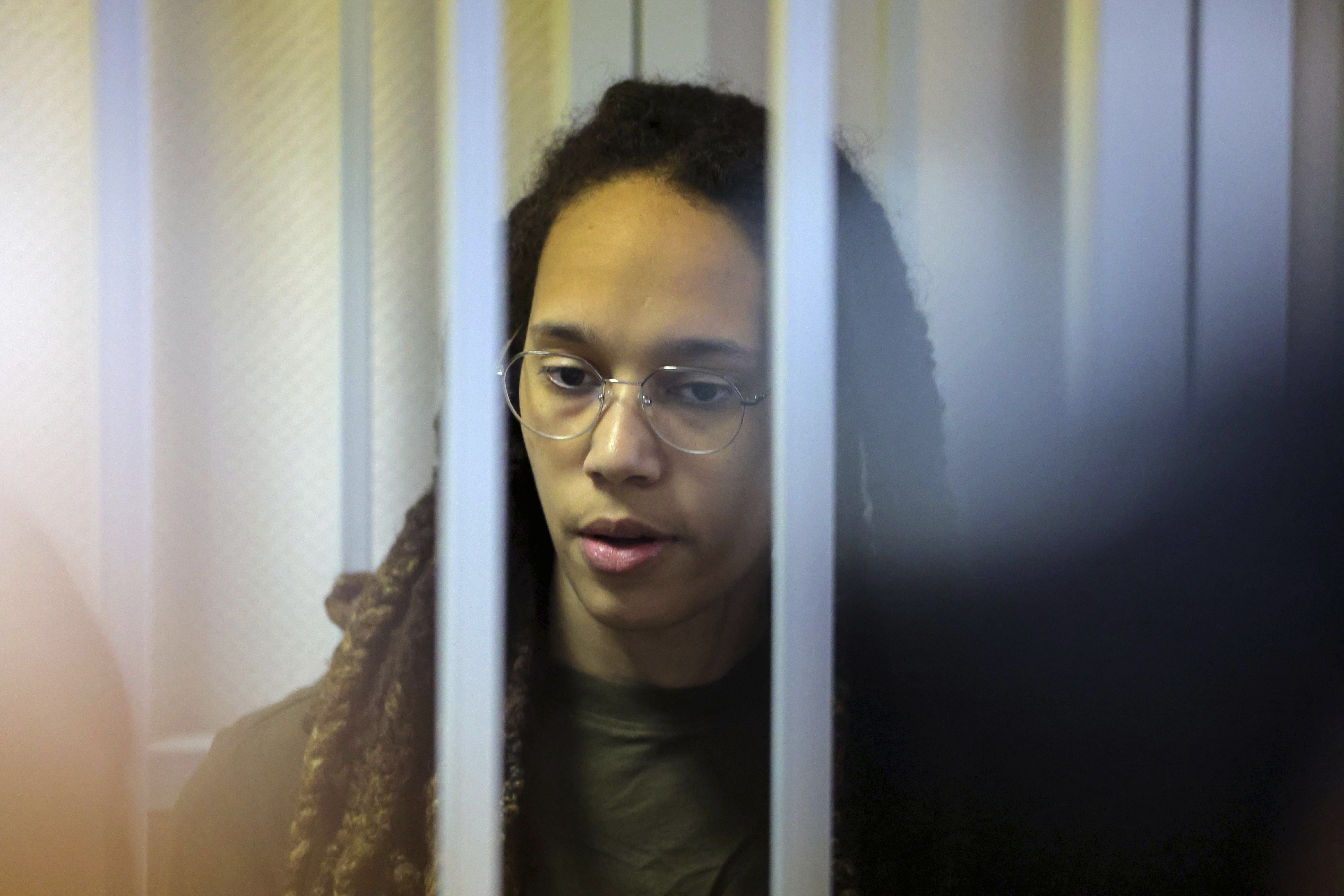 WNBA star and two-time Olympic gold medalist Brittney Griner stands behind bars in a courtroom for a hearing, in Khimki just outside Moscow, Russia, Tuesday, Aug. 2, 2022. Since Brittney Griner last appeared in her trial for cannabis possession, the question of her fate expanded from a tiny and cramped courtroom on Moscow's outskirts to the highest level of Russia-US diplomacy. 
