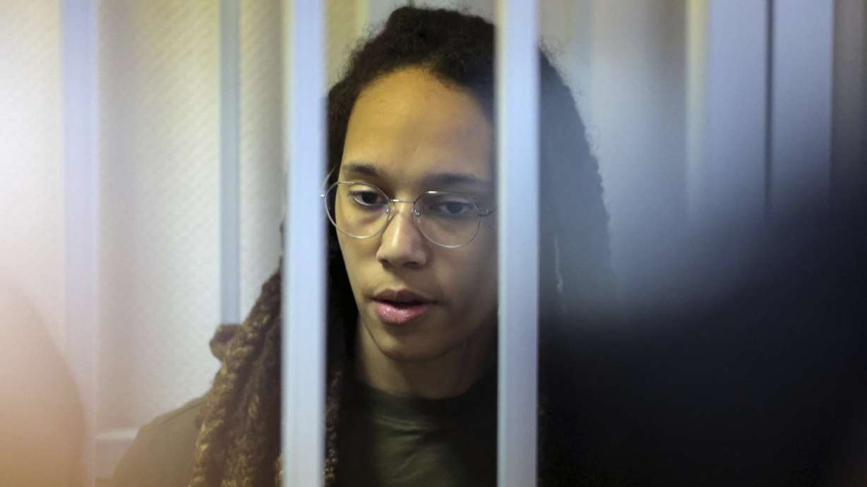 WNBA star and two-time Olympic gold medalist Brittney Griner stands behind bars in a courtroom for a hearing, in Khimki just outside Moscow, Russia, Tuesday, Aug. 2, 2022. Since Brittney Griner last appeared in her trial for cannabis possession, the question of her fate expanded from a tiny and cramped courtroom on Moscow's outskirts to the highest level of Russia-US diplomacy.