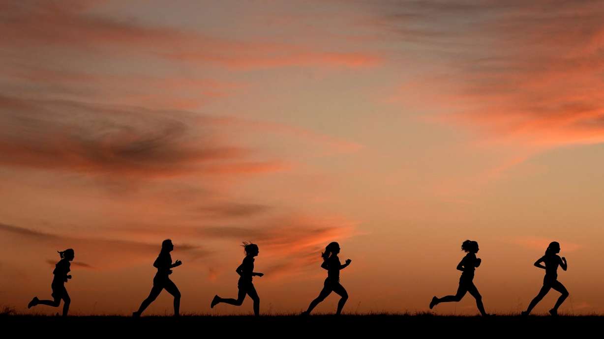High school students run at sunset as they practice for the track and field season Feb. 28, in Shawnee, Kan. New research hints that even simple exercise just might help fend off memory problems. While physical activity helps keep healthy brains fit, it's not clear how much it helps once memory starts to slide.