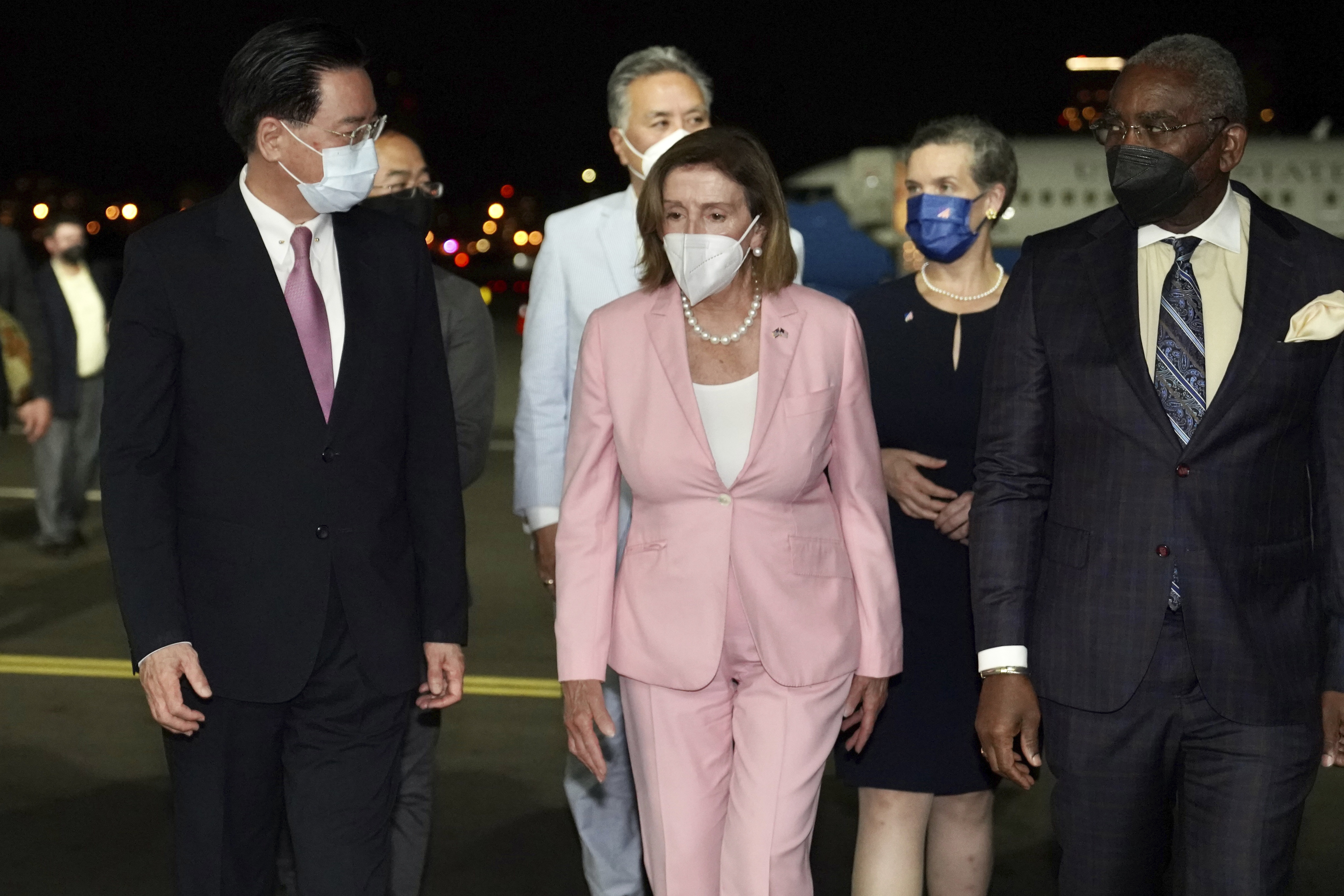 U.S. House Speaker Nancy Pelosi, center, walks with Taiwan's Foreign Minister Joseph Wu, left, as she arrives in Taipei, Taiwan, Tuesday. Pelosi arrived in Taiwan on Tuesday night despite threats from Beijing of serious consequences, becoming the highest-ranking American official to visit the self-ruled island claimed by China in 25 years.