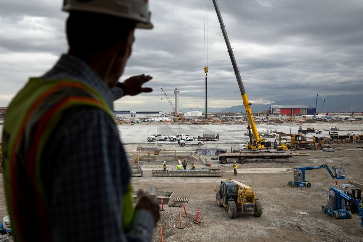 Mike Williams, program director of the Salt Lake City International Airport Redevelopment Program, gestures toward ongoing construction on the central tunnel at the airport in Salt Lake City on Tuesday, Aug. 2, 2022. Once completed, the tunnel will open another way for passengers to transit between Concourse A and Concourse B and eventually to a future Concourse C.