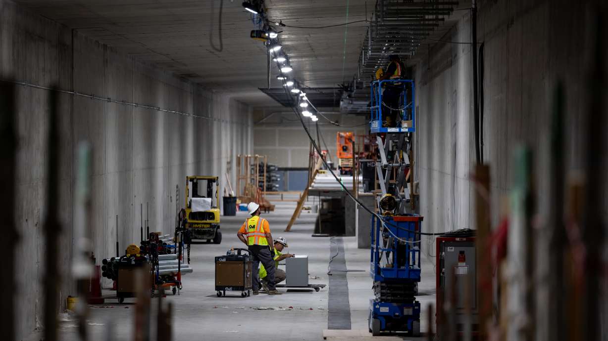 Crews work in a tunnels at the Salt Lake City International Airport in Salt Lake City on Aug. 2, 2022. Airport executives are seeking new bonds that will help finish the project by 2024.
