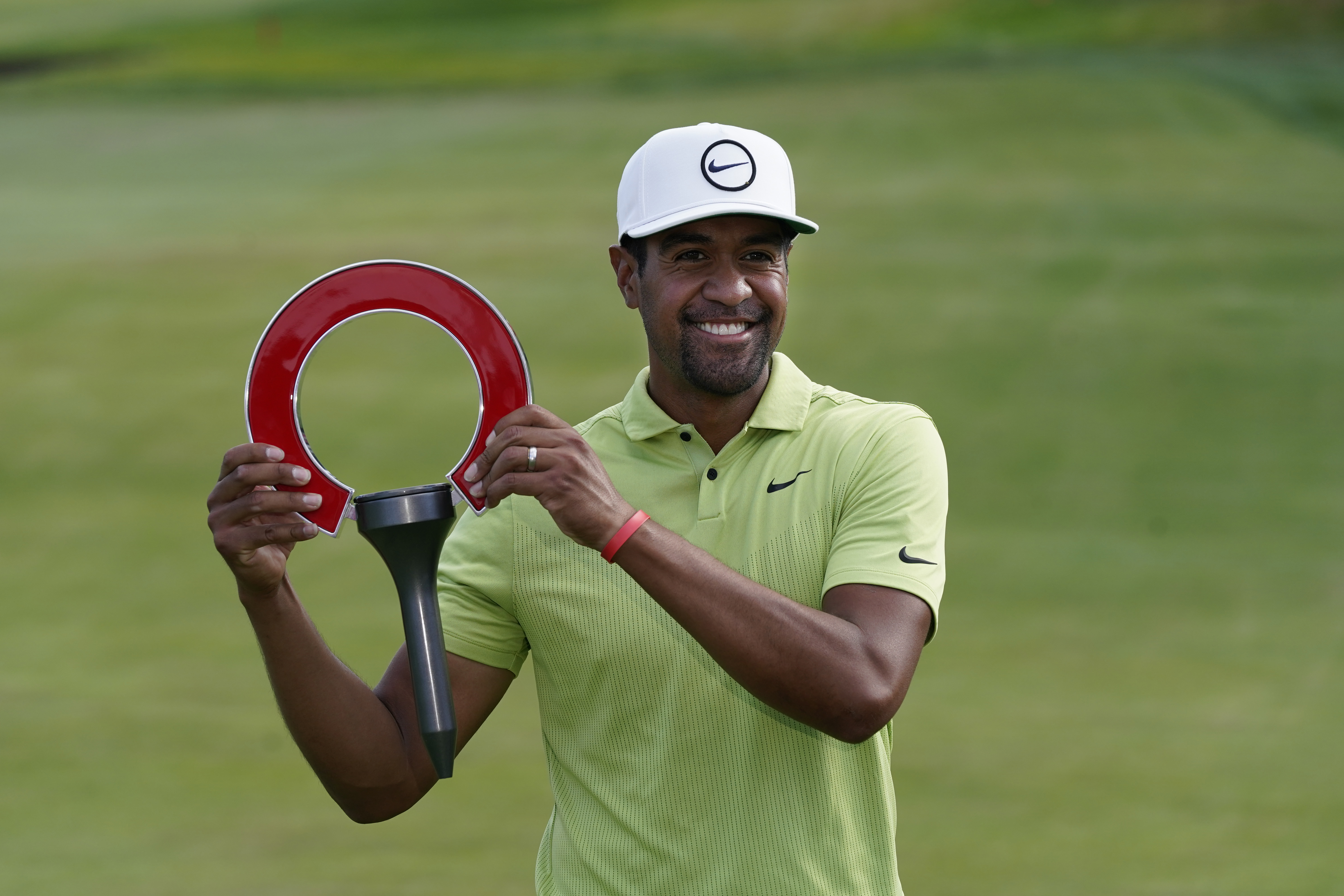 Tony Finau holds the winner's trophy after the final round of the Rocket Mortgage Classic golf tournament, Sunday, July 31, 2022, in Detroit.