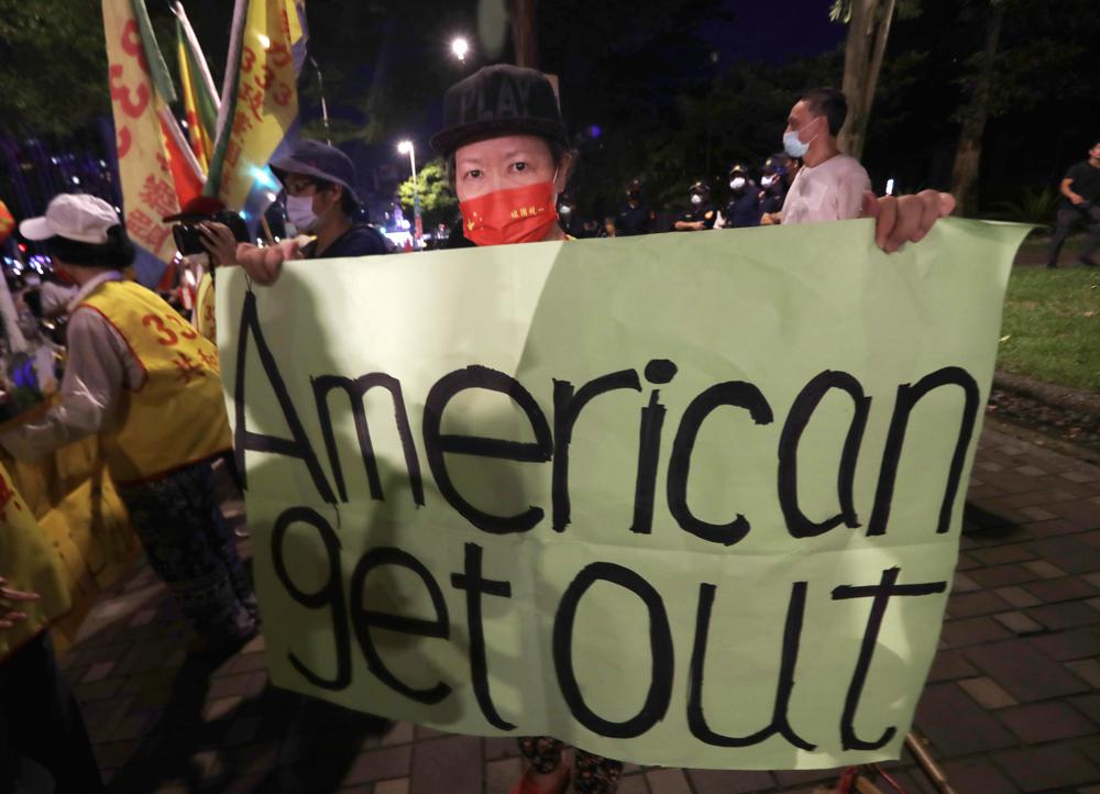 A protester holds a banner during a protest against the visit of United States House Speaker Nancy Pelosi, outside a hotel in Taipei, Taiwan, Tuesday. Pelosi arrived in Taiwan on Tuesday on a visit that could significantly escalate tensions with Beijing, which claims the self-ruled island as its own territory.