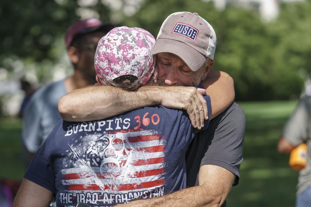 Activist and entertainer Jon Stewart hugs fellow advocate Susan Zeier of Sandusky, Ohio, just after Senate Majority Leader Chuck Schumer, D-N.Y., assured veterans and military family members that the Senate will vote on a bill designed to help millions of veterans exposed to toxic substances during their military service, at the Capitol in Washington, Tuesday.