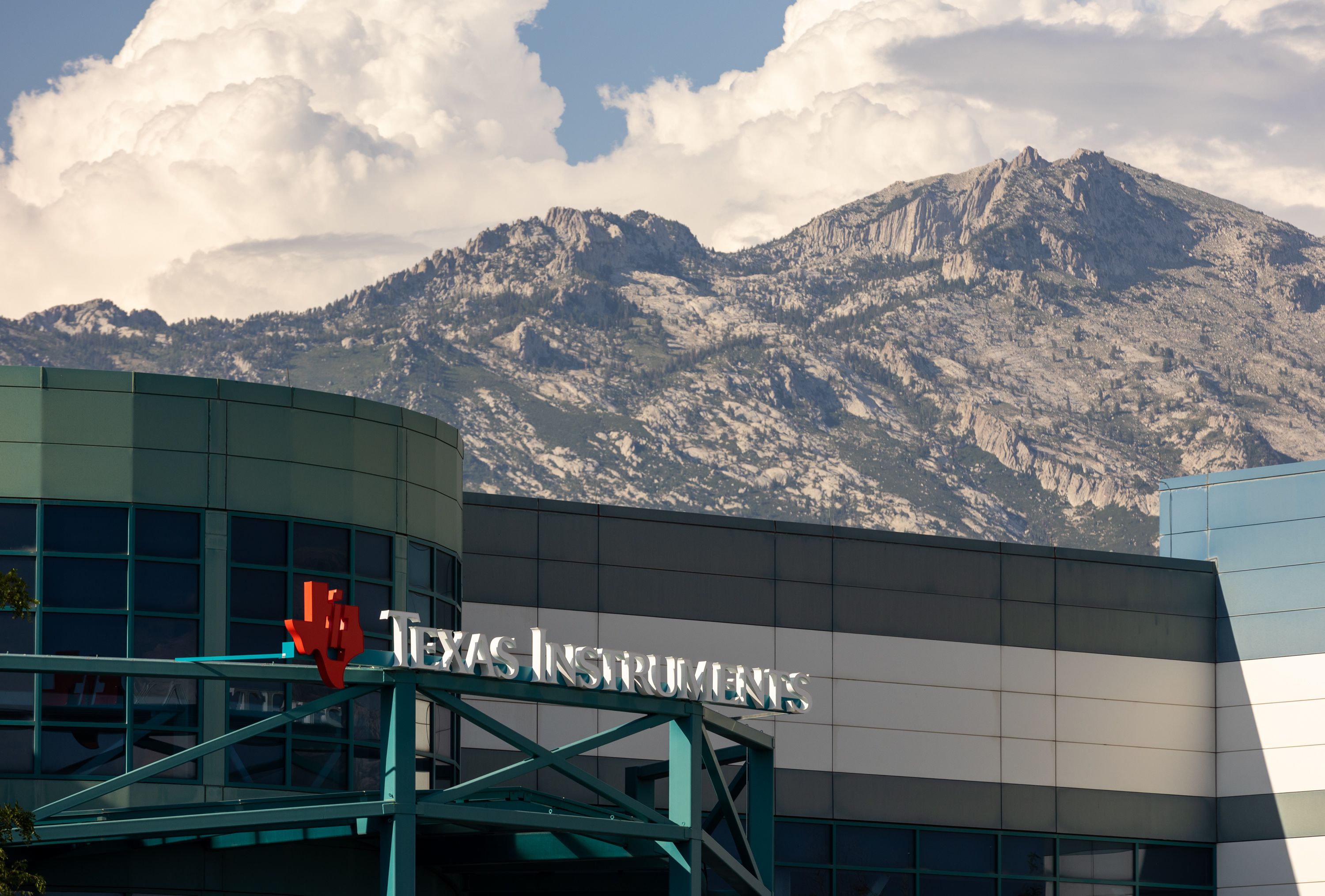 The Texas Instruments logo is seen on the recently bought-out Micron fabrication plant in Lehi on July 28. A massive $280 billion federal proposal aimed at bolstering the once-dominant U.S. microchip industry drew bipartisan support in both the House and Senate and is virtually assured of earning the signature of President Joe Biden.