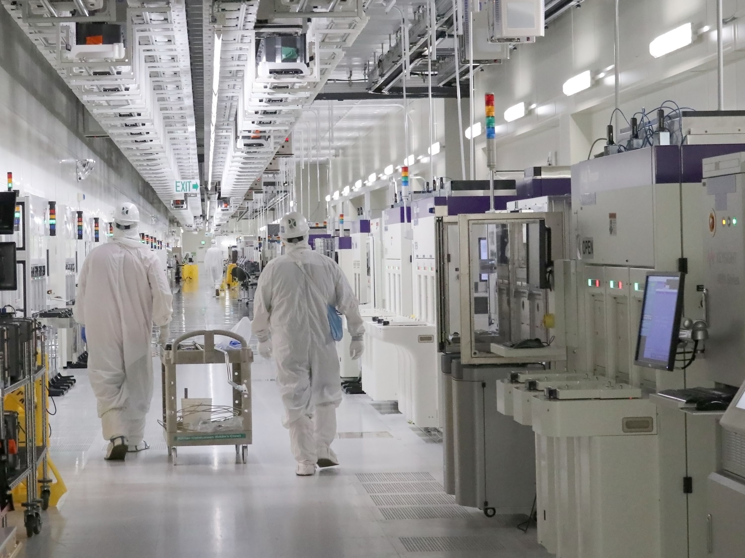 Workers walk through Texas Instruments facility, formerly Micron, in in Lehi in this June 22 image. A massive $280 billion federal proposal aimed at bolstering the once-dominant U.S. microchip industry drew bipartisan support in both the House and Senate and is virtually assured of earning the signature of President Joe Biden.