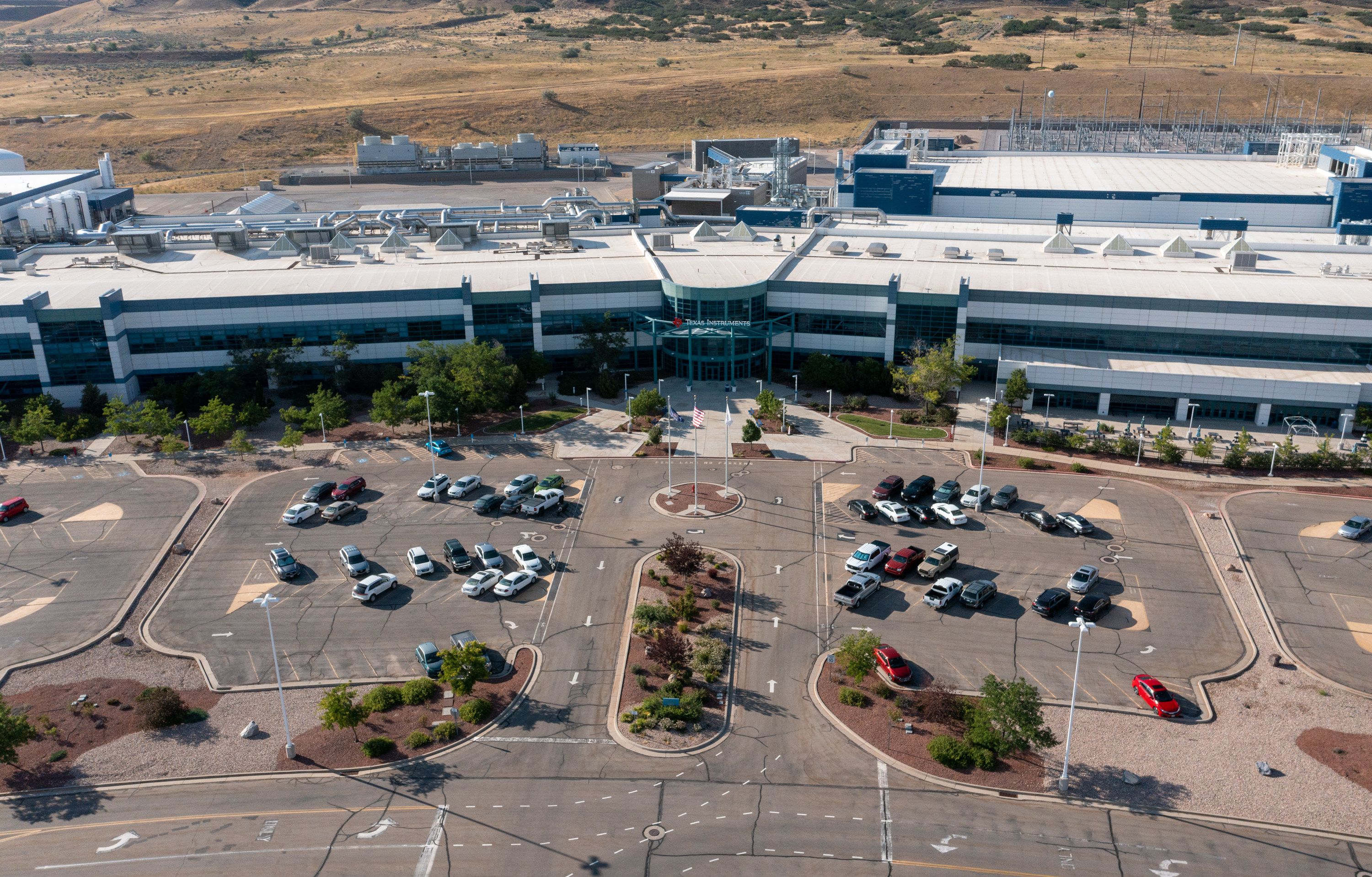 The Texas Instruments logo is seen on the recently bought-out Micron fabrication plant in Lehi, July 28. A massive $280 billion federal proposal aimed at bolstering the once-dominant U.S. microchip industry drew bipartisan support in both the House and Senate and is virtually assured of earning the signature of President Joe Biden.