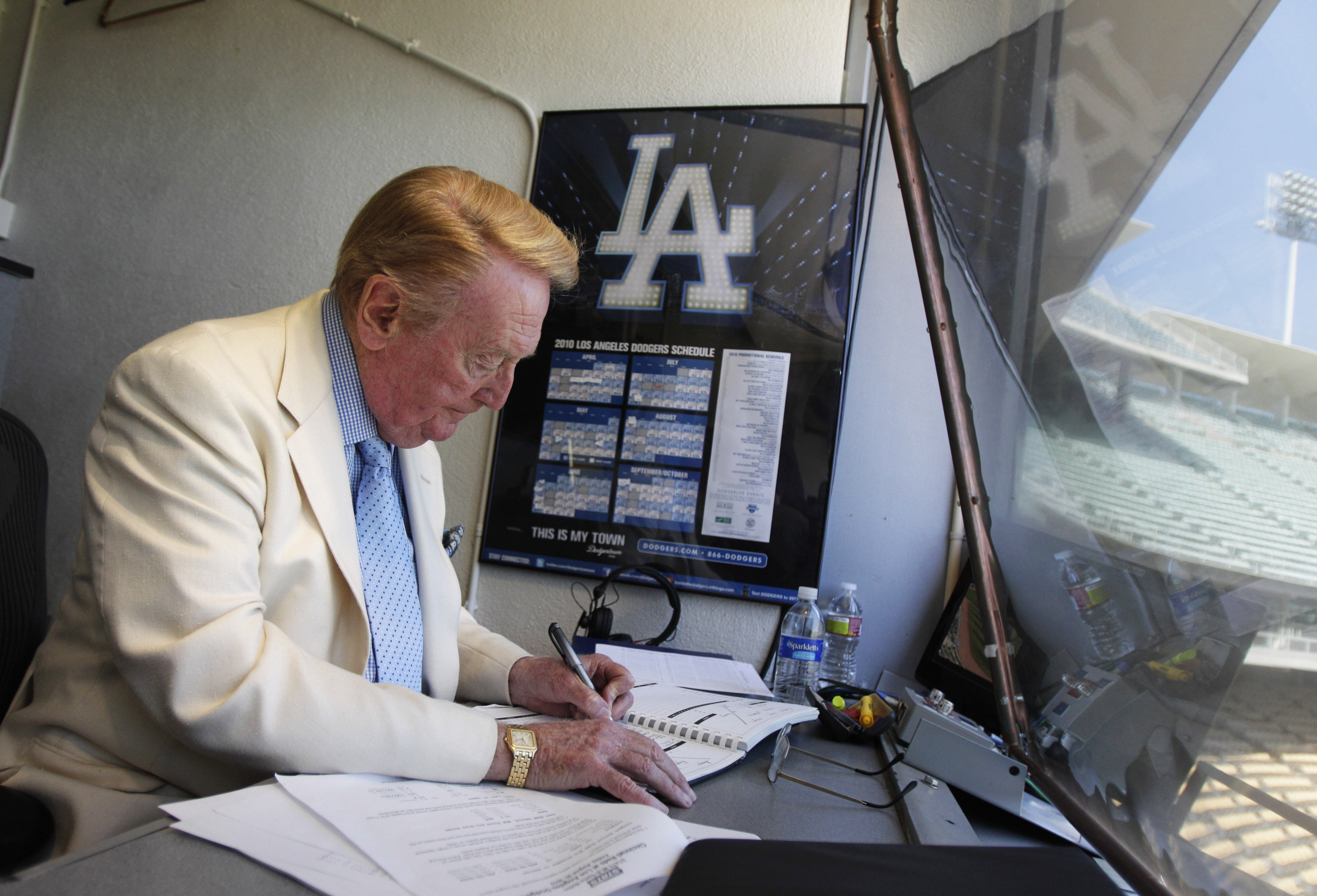 FILE - Vin Scully works in his booth at Dodger Stadium in Los Angeles on Aug. 22, 2010. Scully, whose dulcet tones provided the soundtrack of summer while entertaining and informing Dodgers fans in Brooklyn and Los Angeles for 67 years, died Tuesday night, Aug. 2, 2022, the team said. He was 94.