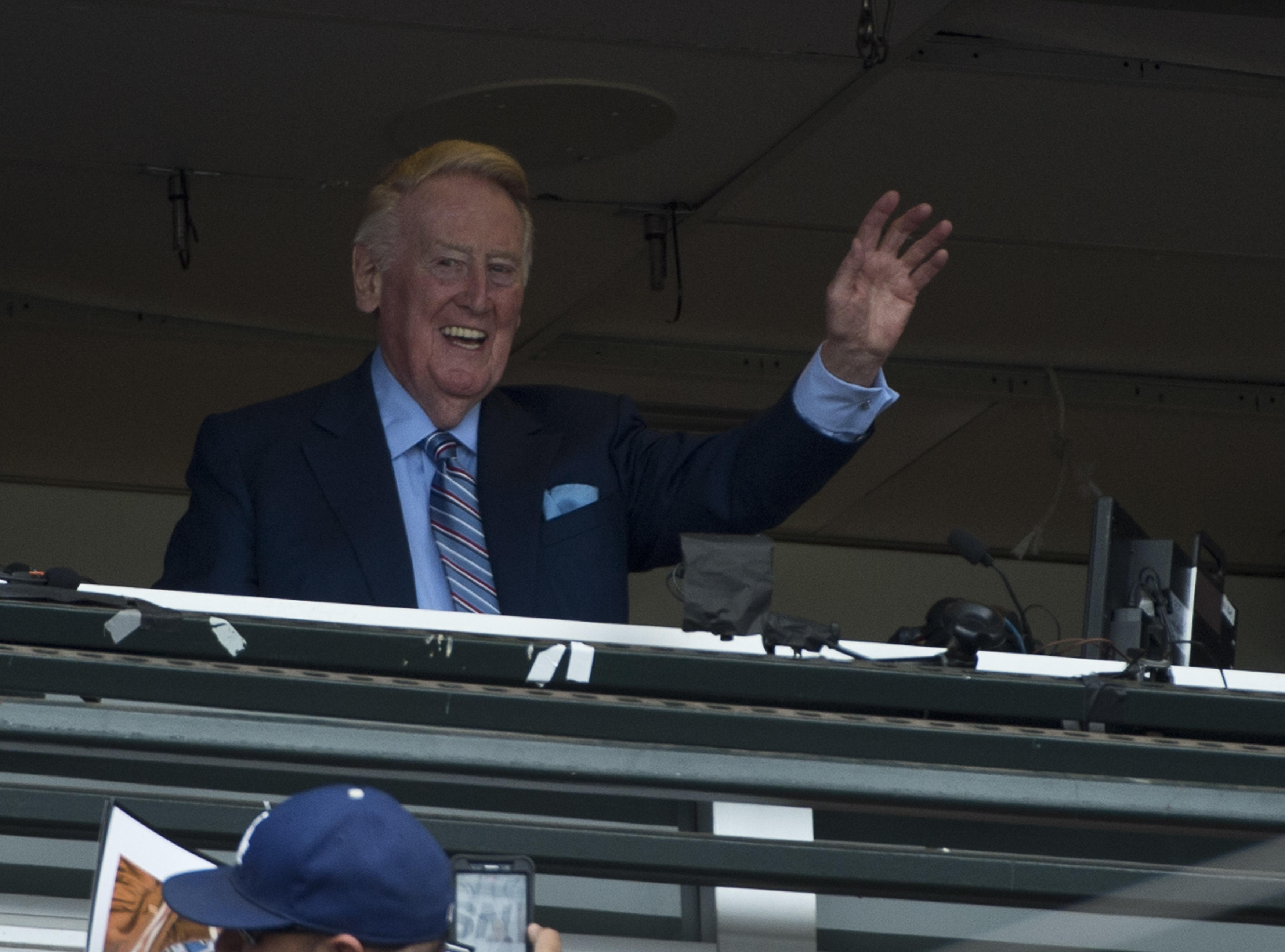 Vin Scully, voice of the Los Angeles Dodgers waves to the crowd before his final broadcast after 67 years, first Brooklyn and then Los Angeles Dodgers, at AT&T Park in San Francisco on October 2, 2016. Scully died on Tuesday.