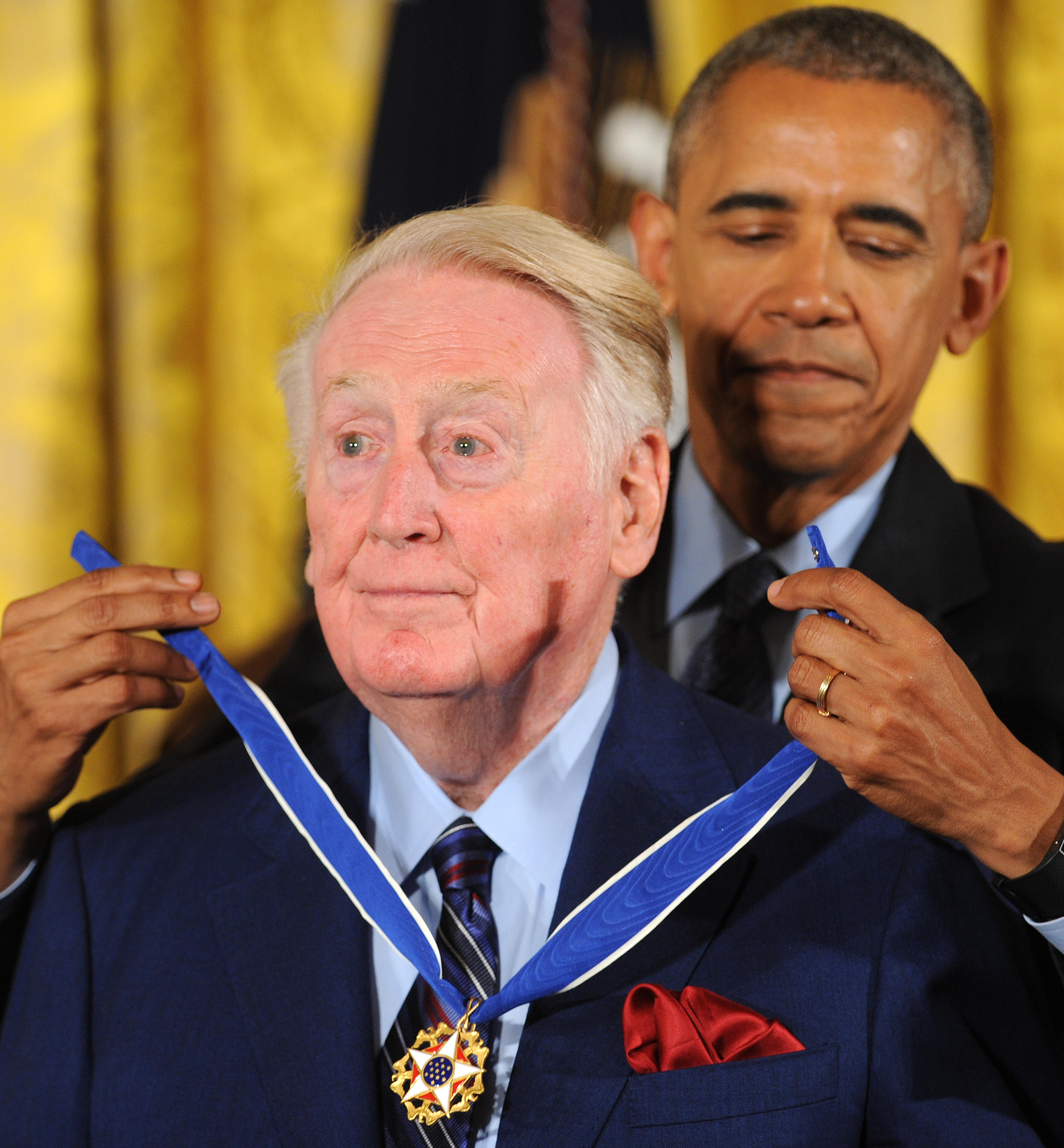 U.S. President Barack Obama presents the Presidential Medal of Freedom to sportscaster Vin Scully in a ceremony in the East Room of the White House on November 22, 2016. The Presidential Medal of Freedom is the highest honor for civilians in the United States. Scully died on Tuesday.