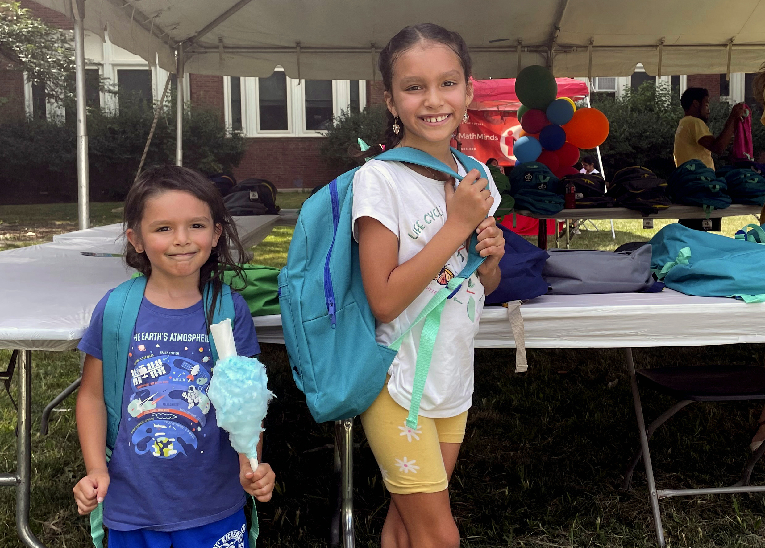 From left, sisters Audrey and Jubilee Colon pick out new backpacks at a Chicago Public Schools back-to-school supply giveaway at Theodore Roosevelt High School in Chicago, on July 22. This back-to-school shopping season, parents, particularly in the low-to-middle income bracket, are focusing on the basics like no-frills rain boots, while also trading down to cheaper stores, including second-hand clothing, as surging inflation takes a toll on their household budgets.