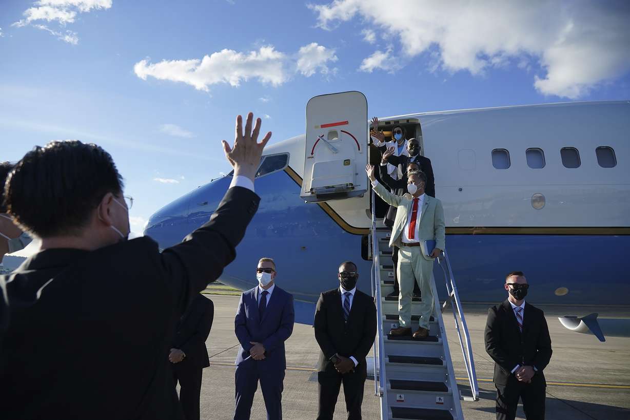 U.S. House Speaker Nancy Pelosi, top, and other members of her delegation wave as they prepare to leave Taipei, Taiwan, Wednesday.