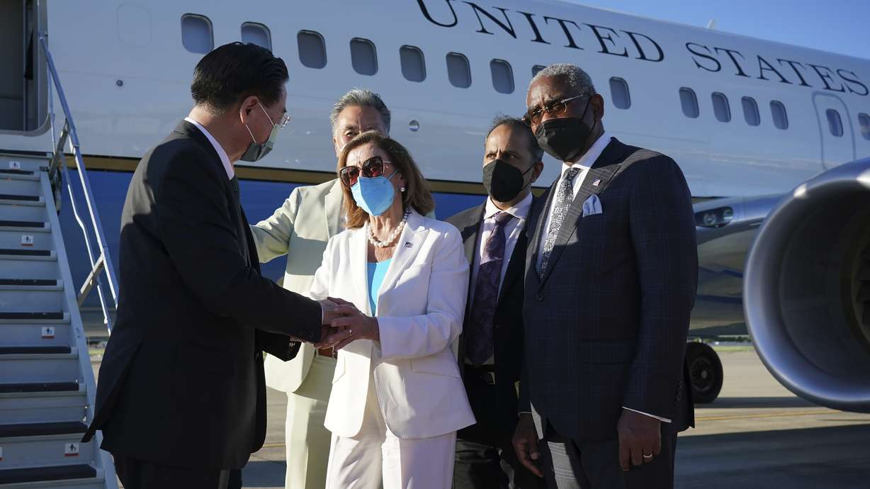 Taiwan's Foreign Minister Joseph Wu, left, speaks with U.S. House Speaker Nancy Pelosi as she prepares to leave Taipei, Taiwan, Wednesday. Pelosi left Taiwan after a visit that heightened tensions with China, saying Wednesday that she and other members of Congress in her delegation showed they will not abandon their commitment to the self-governing island.