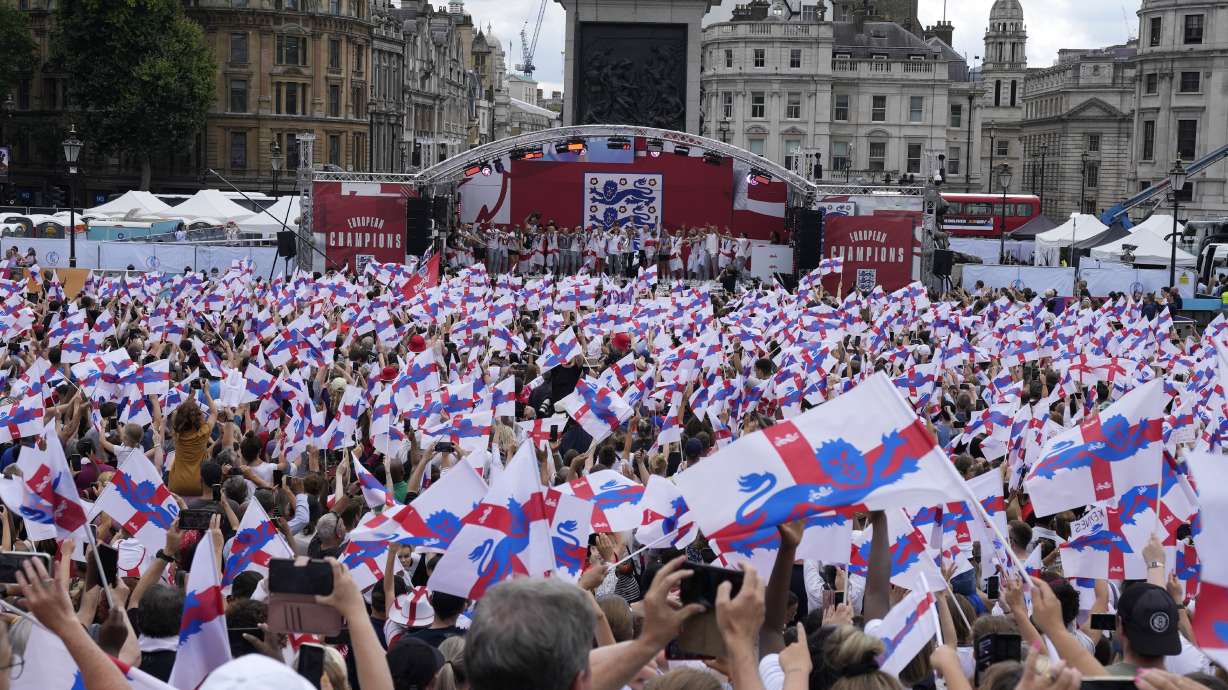 England players celebrate on stage at an event at Trafalgar Square in London, Monday, Aug. 1, 2022. England beat Germany 2-1 and won the final of the Women's Euro 2022 on Sunday.