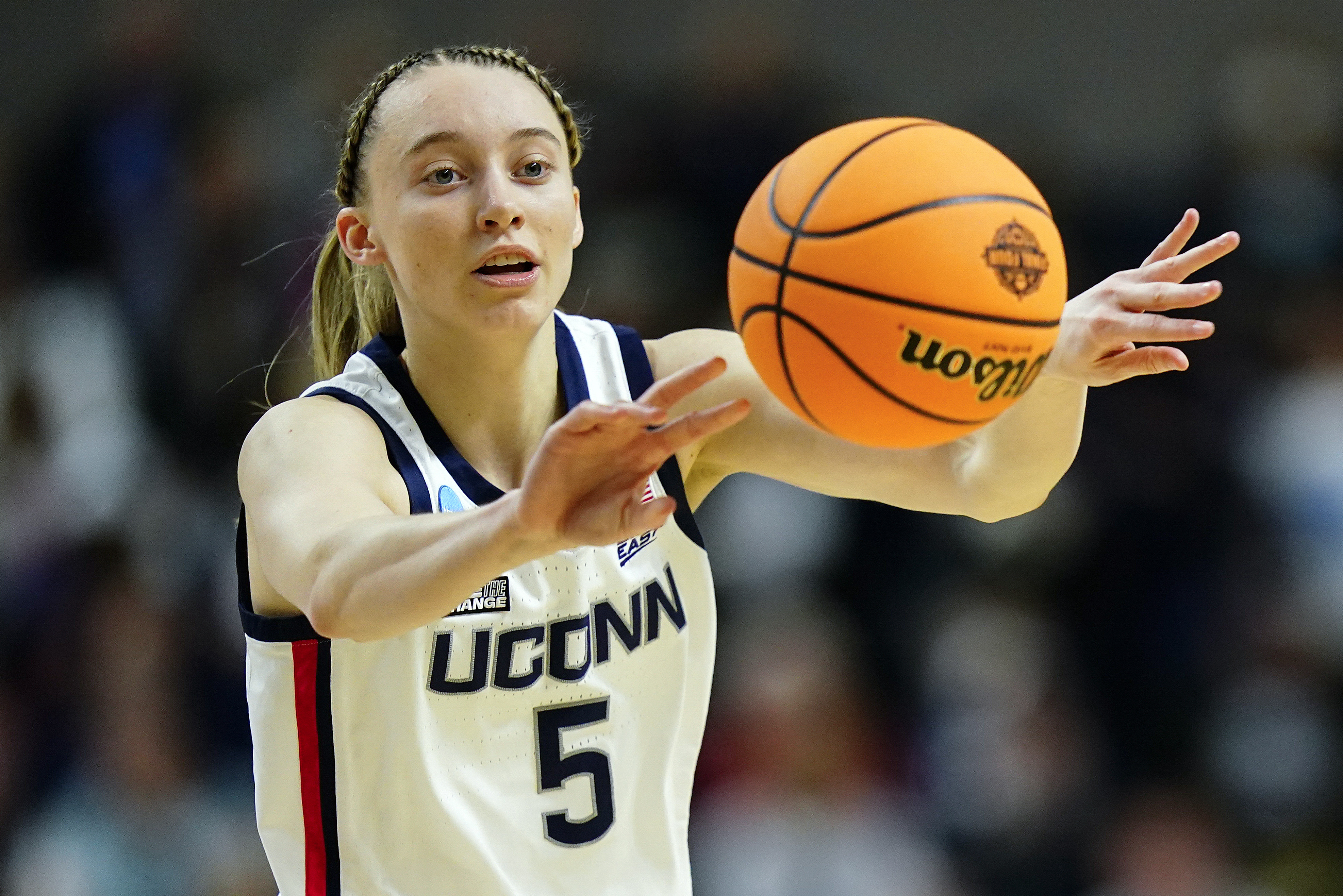 FILE - Connecticut guard Paige Bueckers (5) passes the ball during the first quarter of an NCAA college basketball game against Indiana in the Sweet Sixteen of the NCAA women's tournament on March 26, 2022, in Bridgeport, Conn. Bueckers tore the ACL in her left knee and will miss the entire 2022-23 season, the school announced Wednesday, Aug. 3, 2022.  