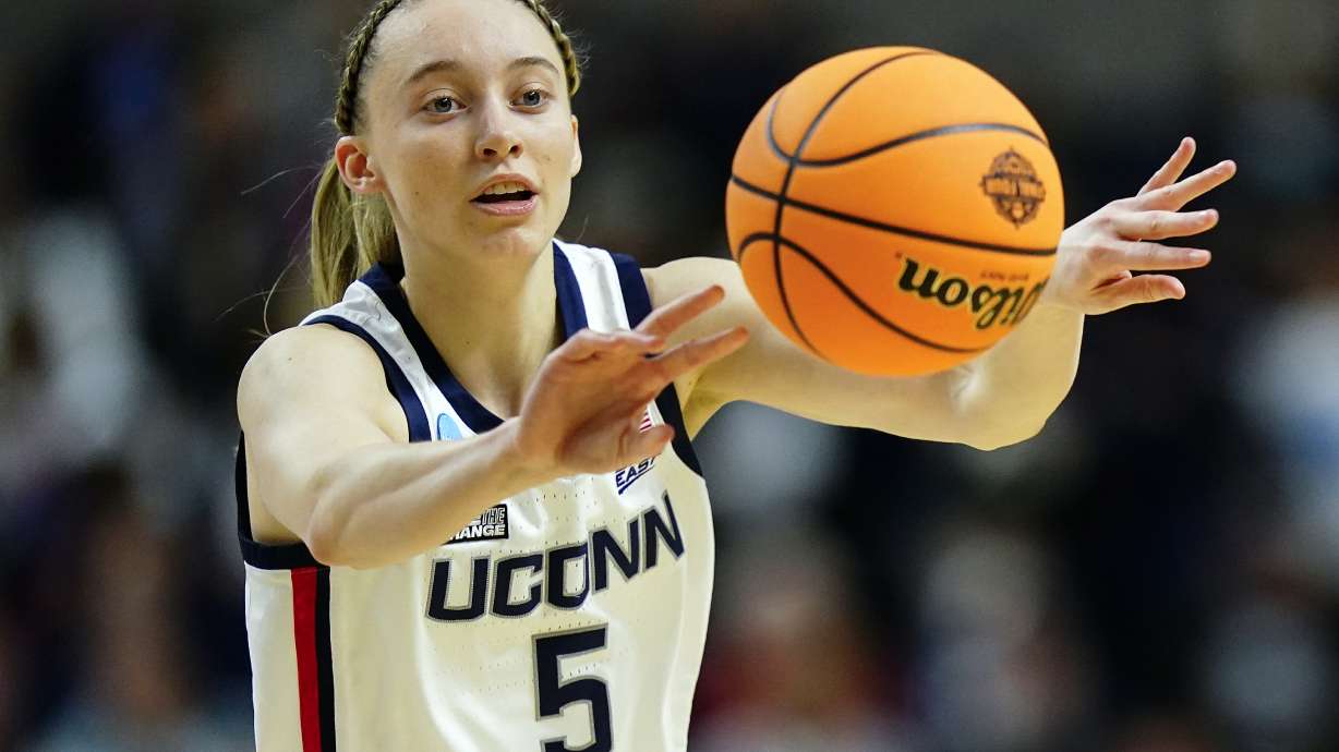 FILE - Connecticut guard Paige Bueckers (5) passes the ball during the first quarter of an NCAA college basketball game against Indiana in the Sweet Sixteen of the NCAA women's tournament on March 26, 2022, in Bridgeport, Conn. Bueckers tore the ACL in her left knee and will miss the entire 2022-23 season, the school announced Wednesday, Aug. 3, 2022.
