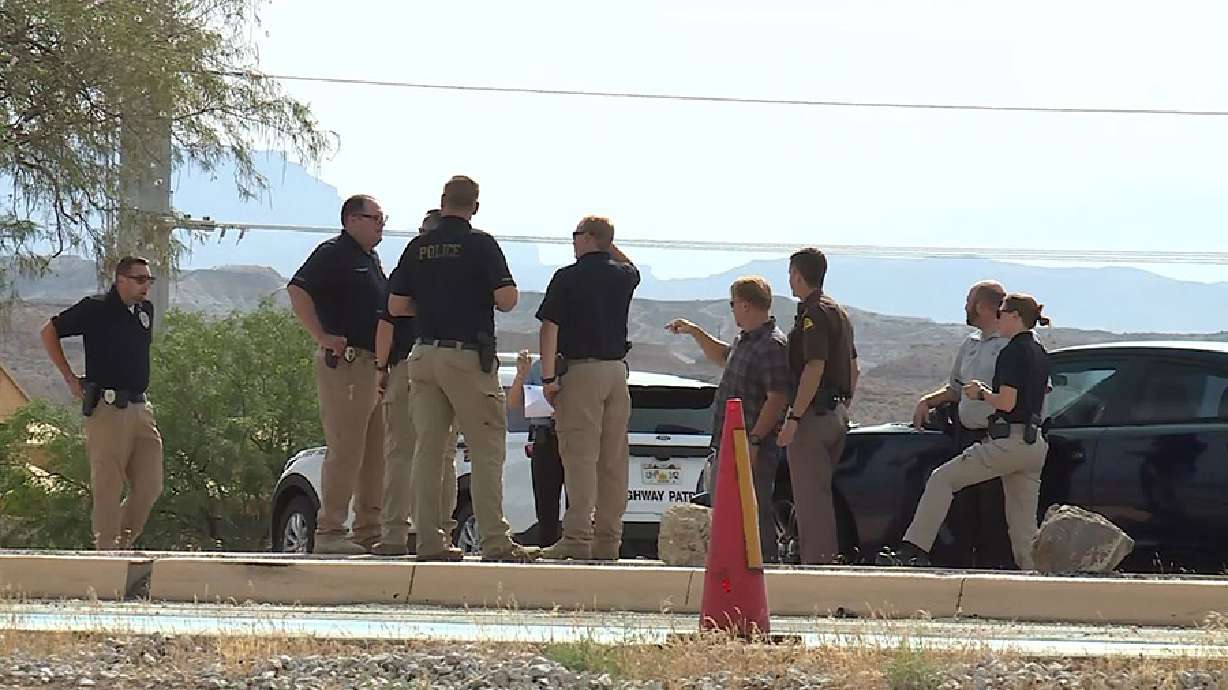 Officers at the scene of a police shooting death near the Utah-Arizona border on Aug. 3. The elderly victim had pointed a weapon at officers before he was shot, court documents say.
