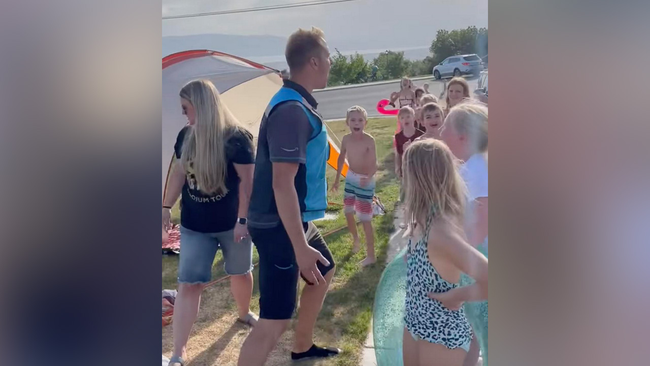 In this YouTube video, an Amazon delivery driver made this group of Utah County kids' day by joining in on their slip-and-slide fun.