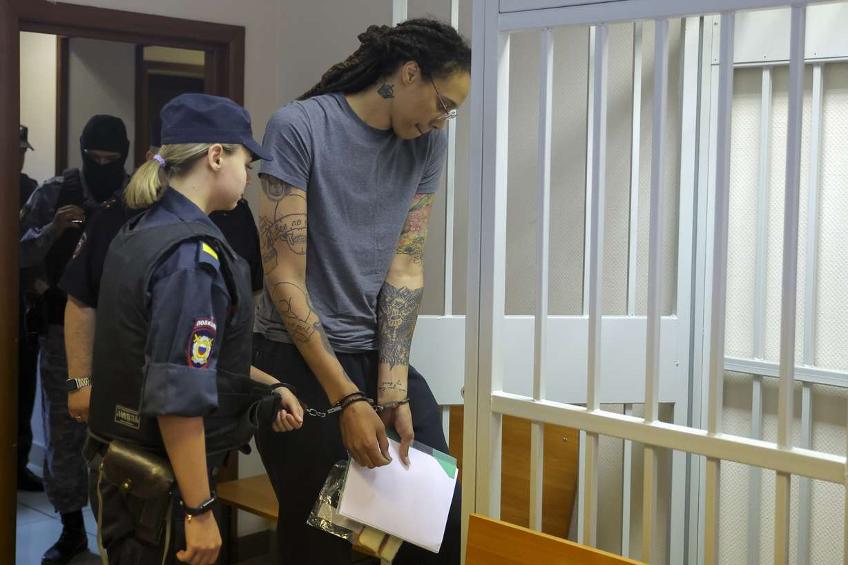 WNBA star and two-time Olympic gold medalist Brittney Griner, right, enters a cage in a courtroom prior to a hearing in Khimki just outside Moscow, Russia, Thursday.