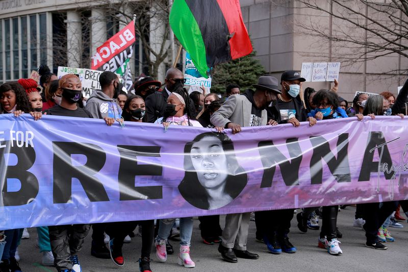 People attend a rally to mark one year since police officers shot and killed Breonna Taylor when they entered her home, in Louisville, Ky., March 13, 2021. The FBI on Thursday arrested and brought civil rights charges against four current and former Louisville, Kentucky, police officers for their roles in the 2020 fatal shooting of Breonna Taylor.