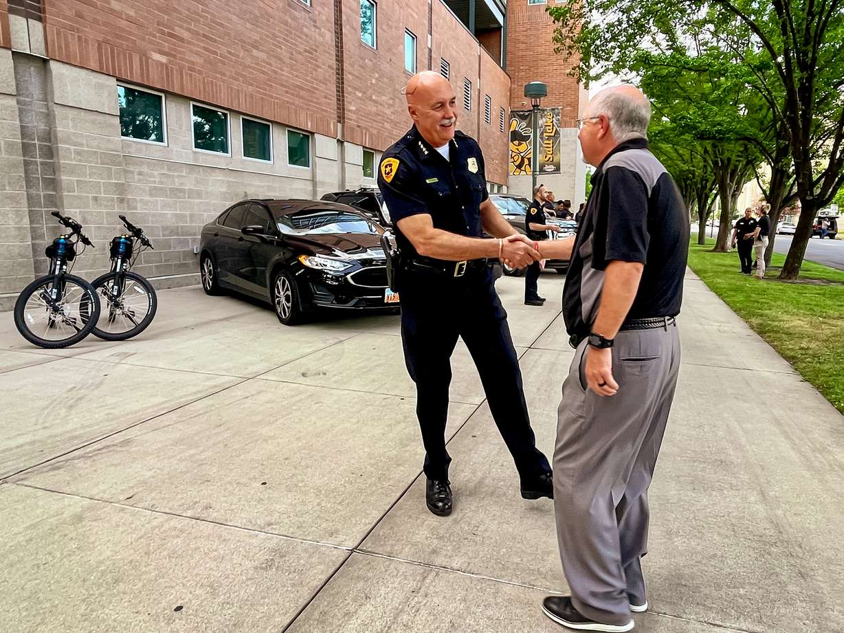 Salt Lake City Police Chief Mike Brown shakes hands with Salt Lake Bees general manager Marc Amicone outside of Smith's Ballpark Thursday morning. The ballpark is the home of a new police substation.