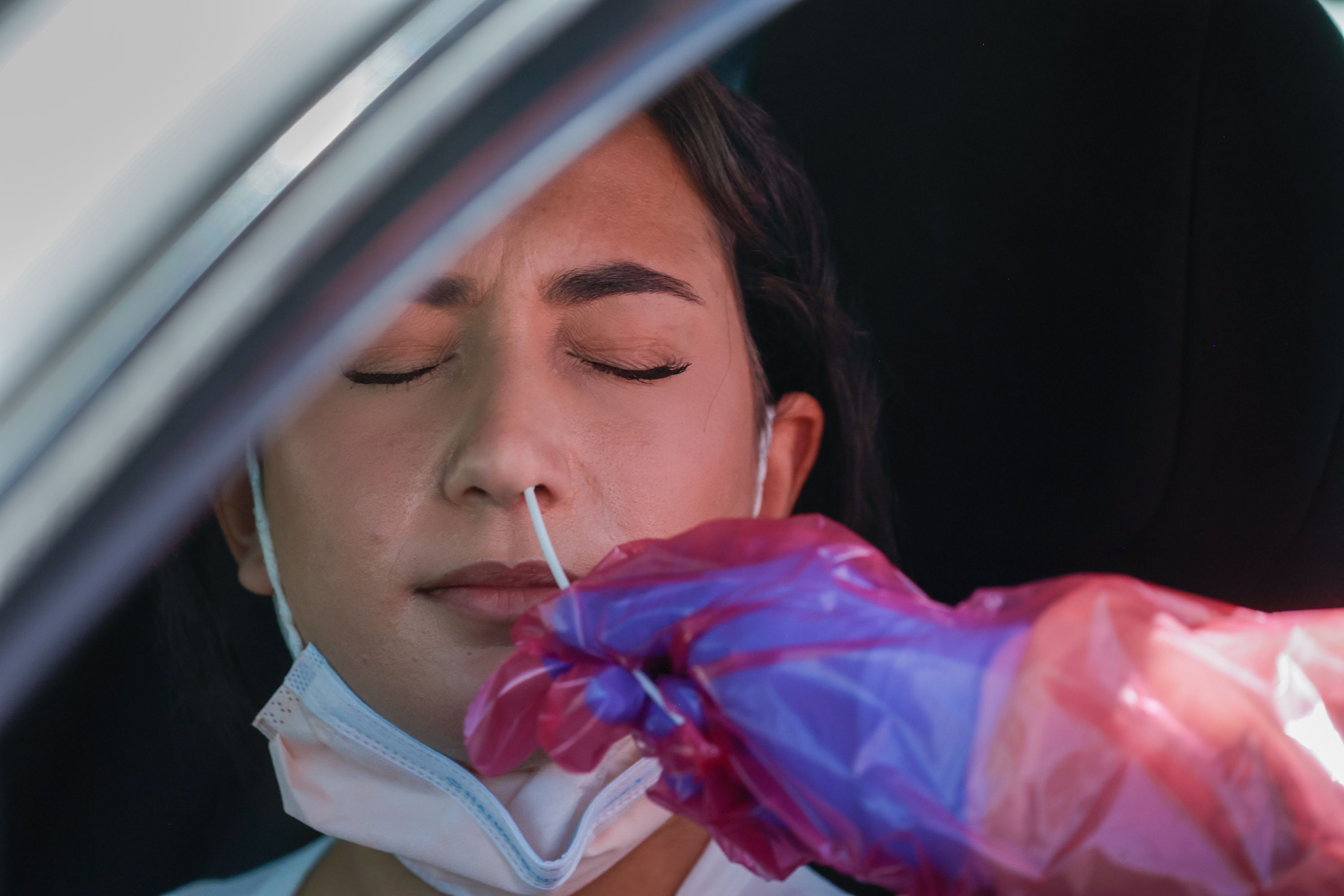 Megan Clay administers a COVID-19 test to Angel Alsammarraie in West Valley City on July 6. Guidelines for slowing the spread of COVID-19 could be relaxed as soon as this week by the U.S. Centers for Disease Control and Prevention.
