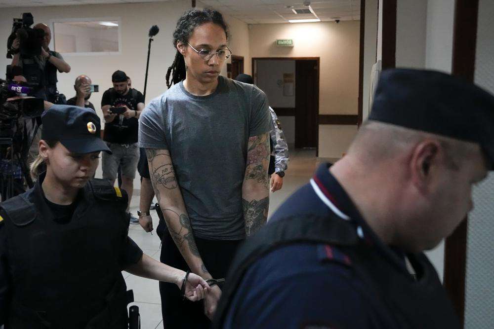 WNBA star and two-time Olympic gold medalist Brittney Griner, center, is escorted in a court room prior to a hearing, in Khimki just outside Moscow, Russia, Thursday. Griner was given a 9-year sentence weeks after her guilty plea.