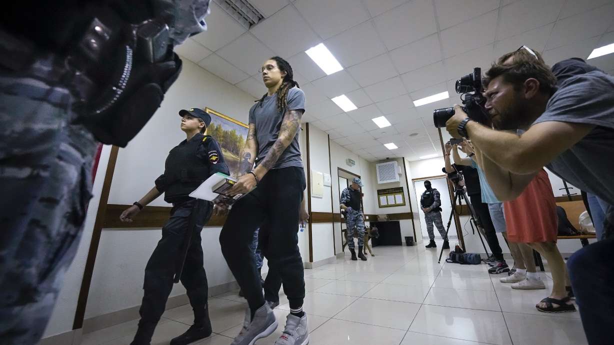 WNBA star and two-time Olympic gold medalist Brittney Griner is escorted from a court room ater a hearing, in Khimki just outside Moscow, Russia, Thursday, Aug. 4, 2022. A judge in Russia has convicted American basketball star Brittney Griner of drug possession and smuggling and sentenced her to nine years in prison.
