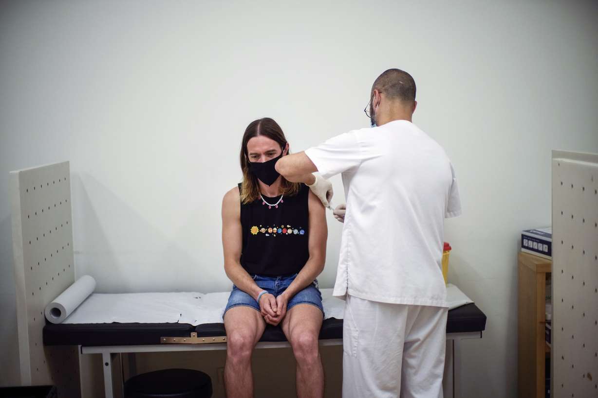 Daniel Rofin, 41, receives a vaccine against Monkeypox from a health professional in medical center in Barcelona, Spain, July 26.