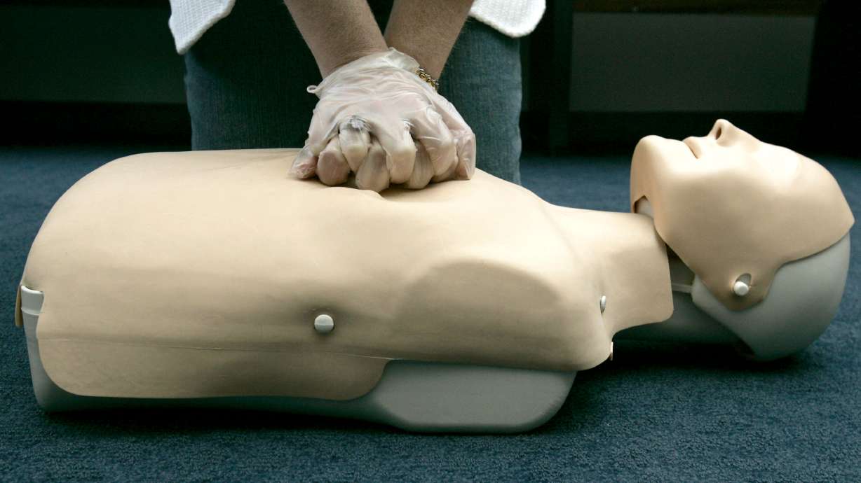 In this Sept. 15, 2006, photo a person participates in an American Red Cross CPR training in Washington. High school students in the Beehive State will have more than a diploma under their belt after graduation as they are now required to undergo CPR training as part of the state curriculum, one component of an initiative to combat sudden cardiac arrest.
