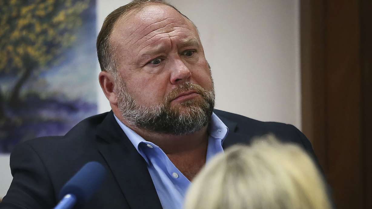 Conspiracy theorist Alex Jones attempts to answer questions during trial in Austin, Texas, on Wednesday. A Texas jury has ordered Jones to pay $49.3 million in total damages to the parents of a first grader killed in the 2012 Sandy Hook Elementary School massacre.
