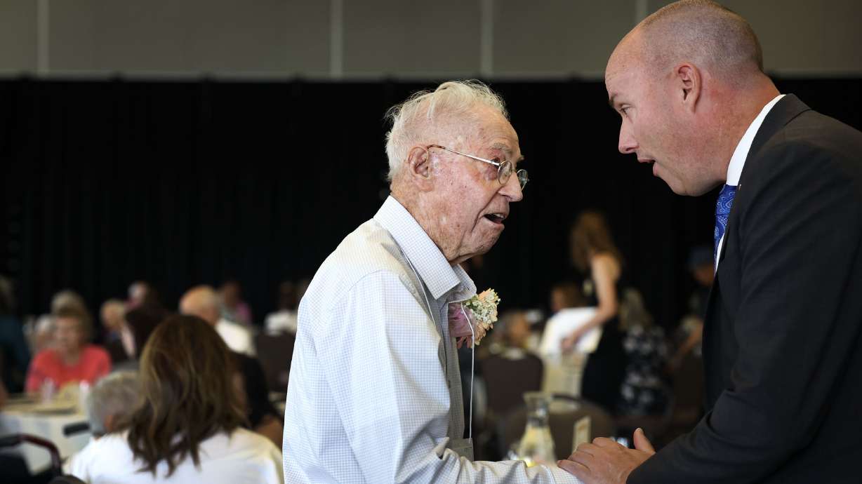 Weldon Heaton, 101, chats with Gov. Spencer Cox at the 34th annual Centenarian Celebration at the Viridian Event Center in West Jordan on Thursday.