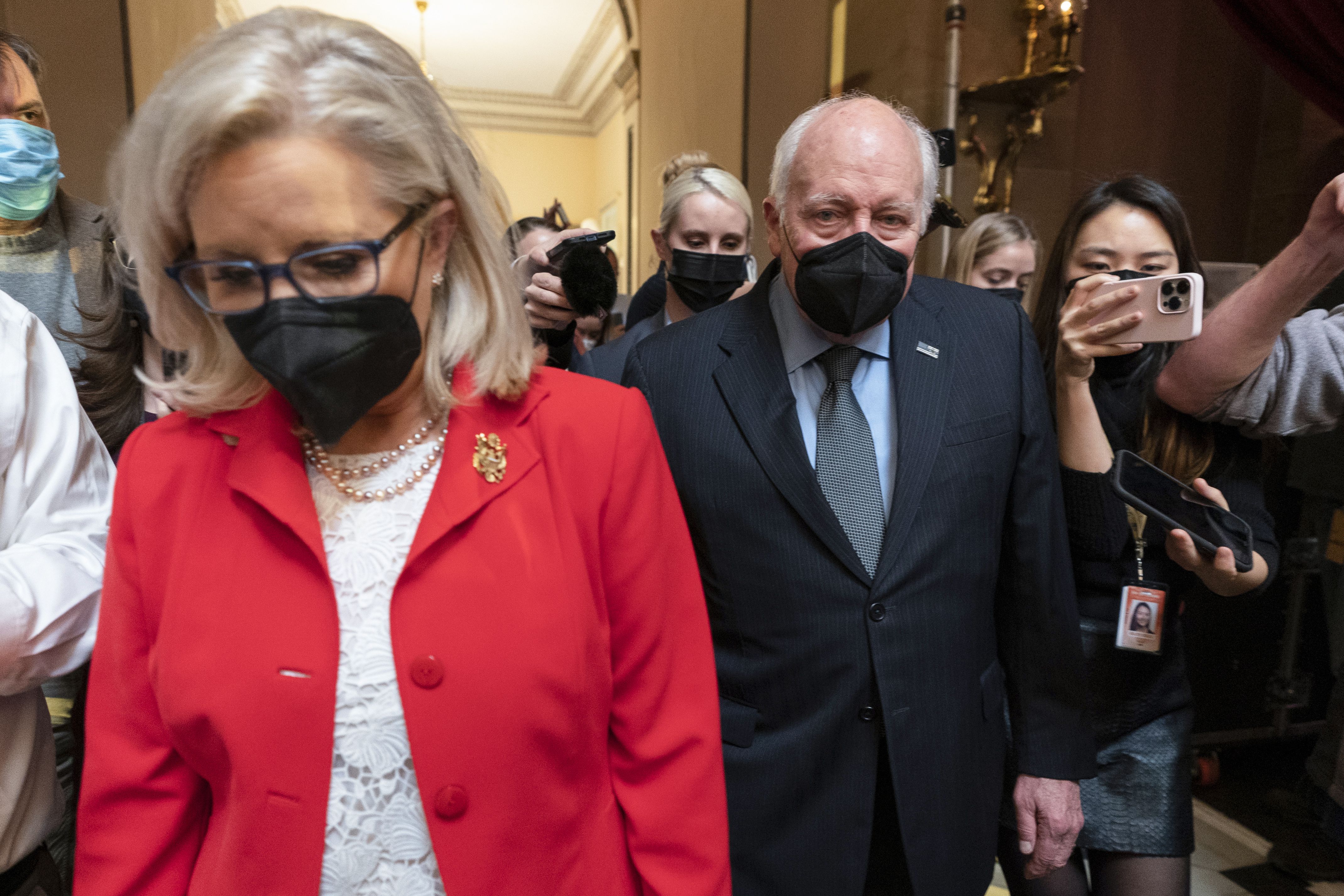 Former Vice President Dick Cheney walks with his daughter Rep. Liz Cheney, R-Wyo., in the Capitol Rotunda at the Capitol in Washington on Jan. 6. Dick Cheney calls Donald Trump a "threat to our republic" and a "coward" in a new campaign ad for his daughter, Wyoming Rep. Liz Cheney.