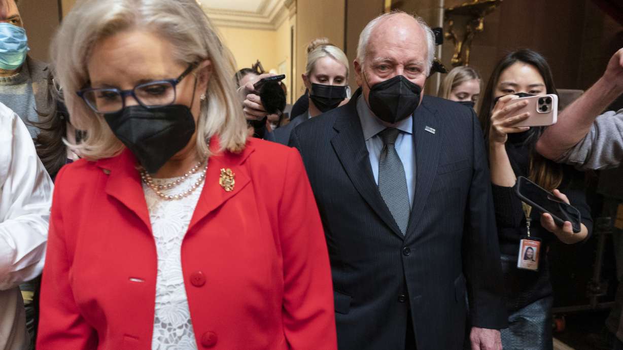 Former Vice President Dick Cheney walks with his daughter Rep. Liz Cheney, R-Wyo., in the Capitol Rotunda at the Capitol in Washington on Jan. 6. Dick Cheney calls Donald Trump a "threat to our republic" and a "coward" in a new campaign ad for his daughter, Wyoming Rep. Liz Cheney.