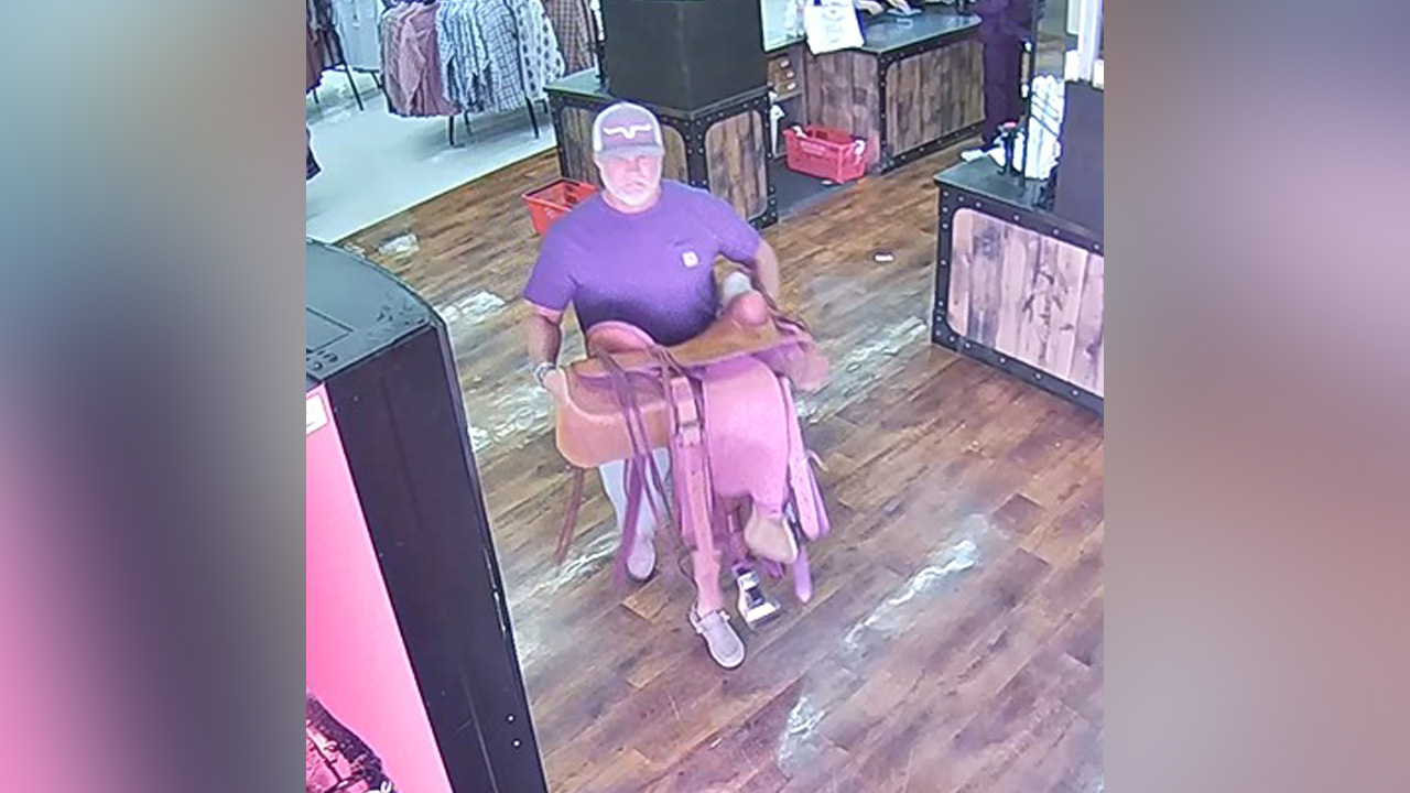 A man suspected of stealing a handmade saddle worth over $2,000 from the Smith & Edwards sporting goods and surplus store in Ogden is seen holding the saddle in this store surveillance image. Police are asking for help identifying him.