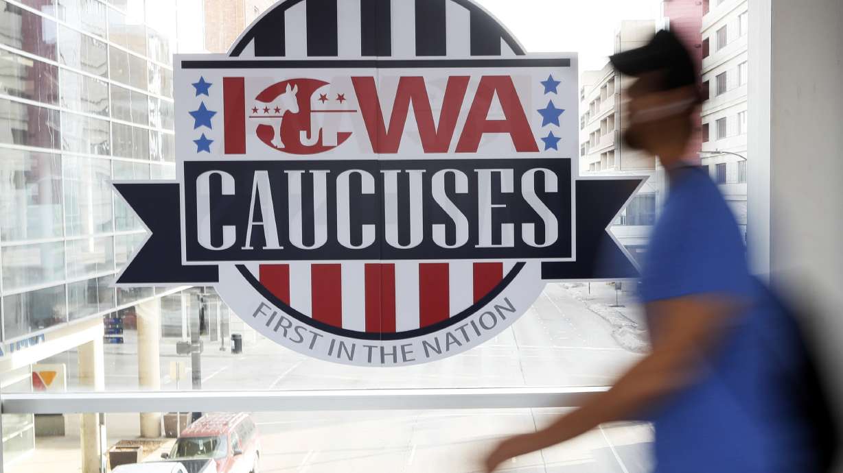 A pedestrian walks past a sign for the Iowa Caucuses on a downtown skywalk, in Des Moines, Iowa, on Feb. 4, 2020. Democrats may be moving toward shaking up their presidential nominating process starting in 2024.