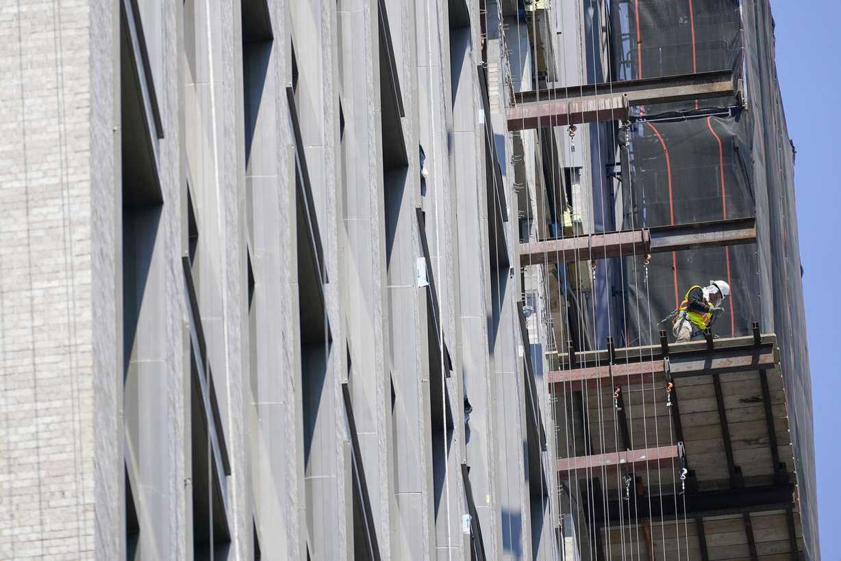 Construction workers are seen working on a high-rise residential and commercial building under construction at the Essex Crossing development on the Lower East Side of Manhattan, Thursday.