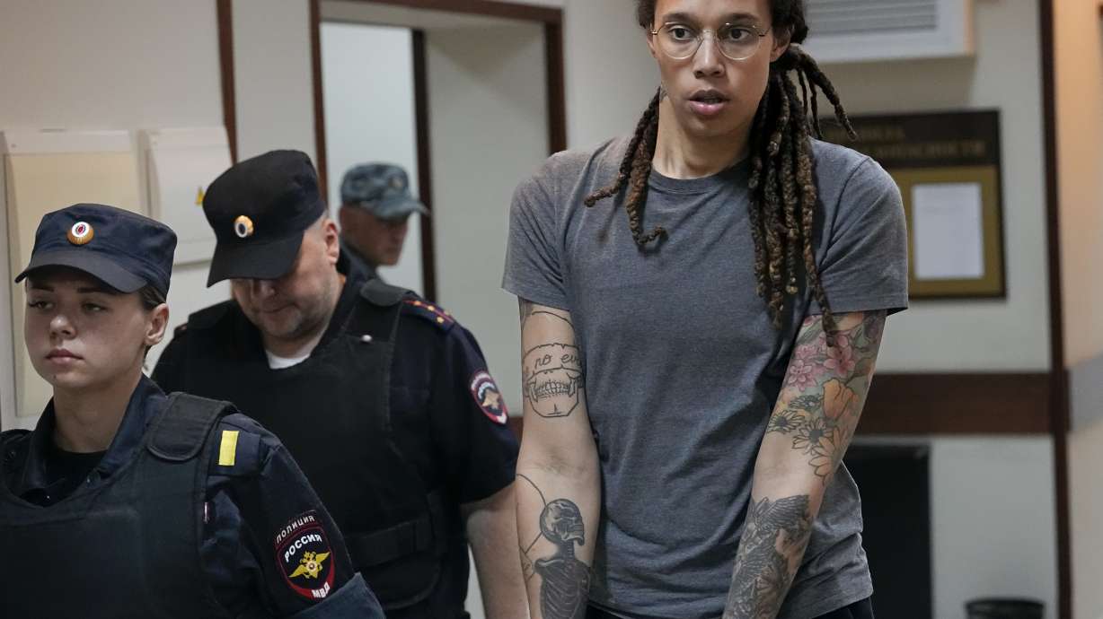WNBA star and two-time Olympic gold medalist Brittney Griner is escorted from a court room ater a hearing, in Khimki just outside Moscow, Russia, Thursday, Aug. 4, 2022. A judge in Russia has convicted American basketball star Brittney Griner of drug possession and smuggling and sentenced her to nine years in prison.